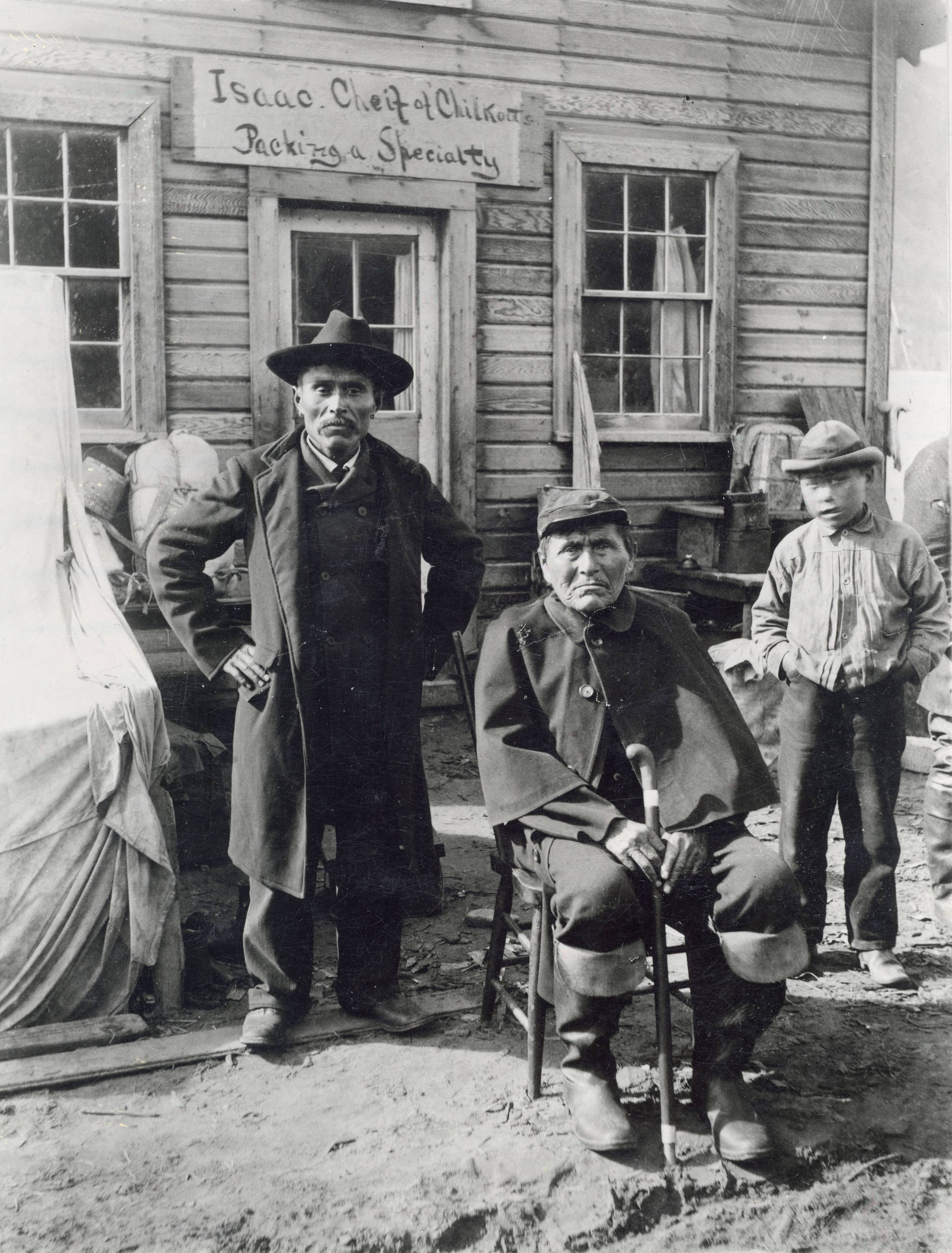 Chief Isaac, left, and Don-a-wok, center, in front of their store in Dyea in 1897. (Library of Congress, 29265/262-30261 MM III-2; KLGO HW-18-1436)