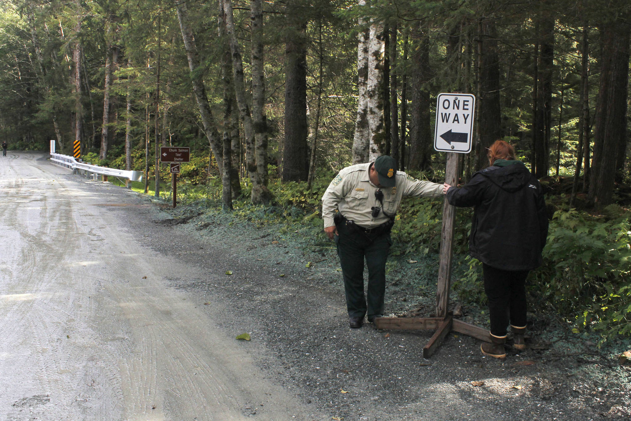 U.S. Forest Service Officer Dave Zuniga and U.S. Forest Service Cabins and Recreation employee Caty Beckel place a road sign at the newly improved Lena Beach Recreation Area on Saturday, Sept. 1, 2018. (Alex McCarthy | Juneau Empire)