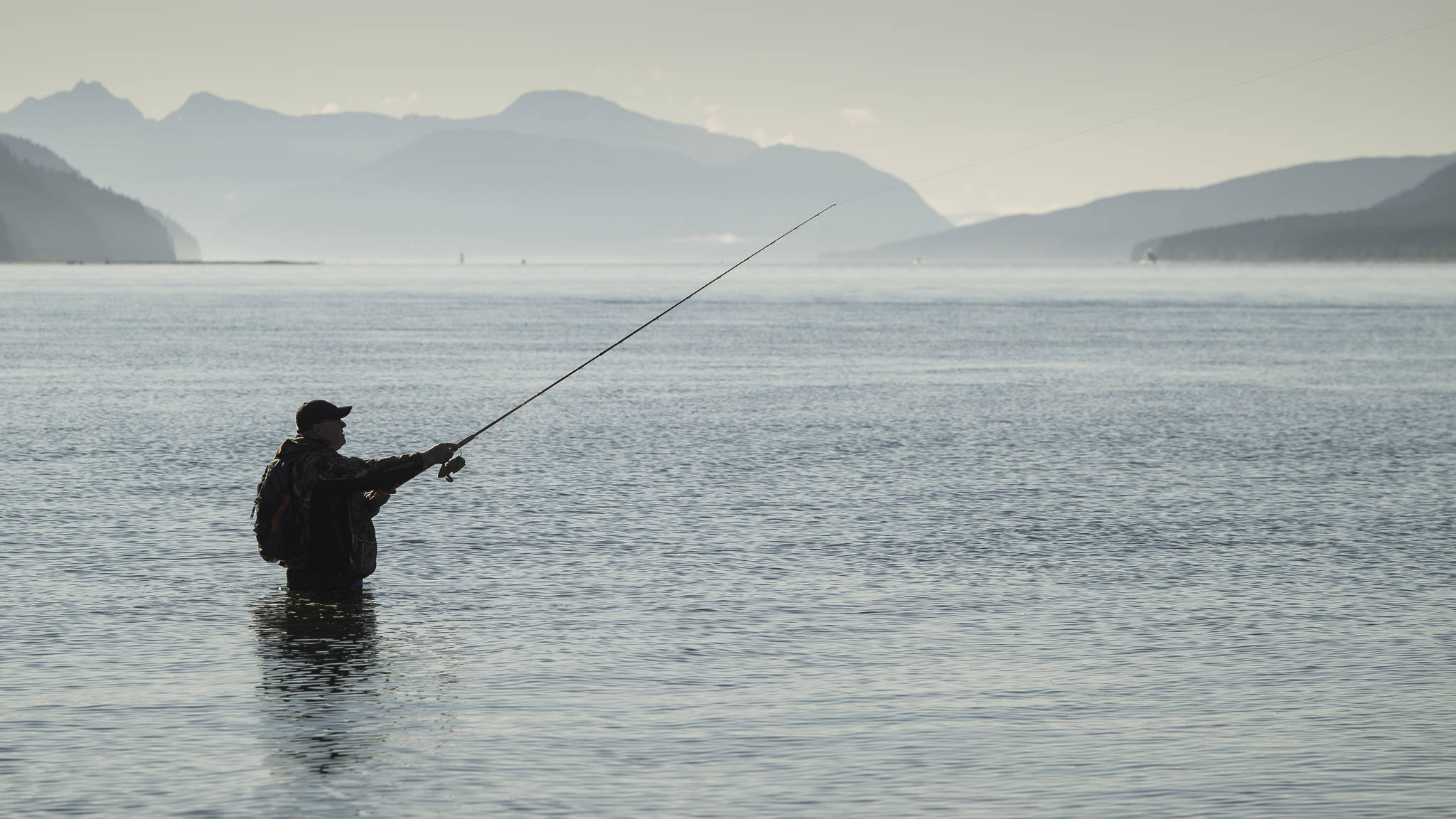Robert Kent enjoys his day off fishing for returning silver salmon in Gastineau Channel on Monday, Sept. 3, 2018. Kent said, “Can’t help but enjoy this day. It’s absolutely amazing.” (Michael Penn | Juneau Empire)