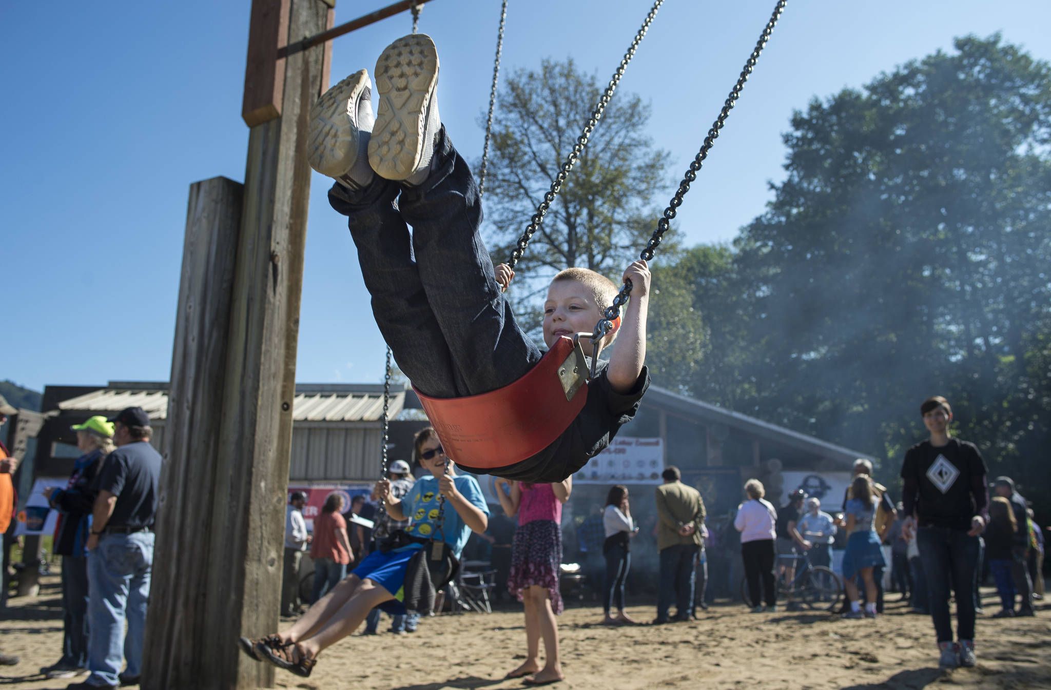 Crystal Koeneman, right, swings her son, Tyr, 6 during the Labor Day picnic at Sandy Beach on Monday, Sept. 3, 2018. (Michael Penn | Juneau Empire)