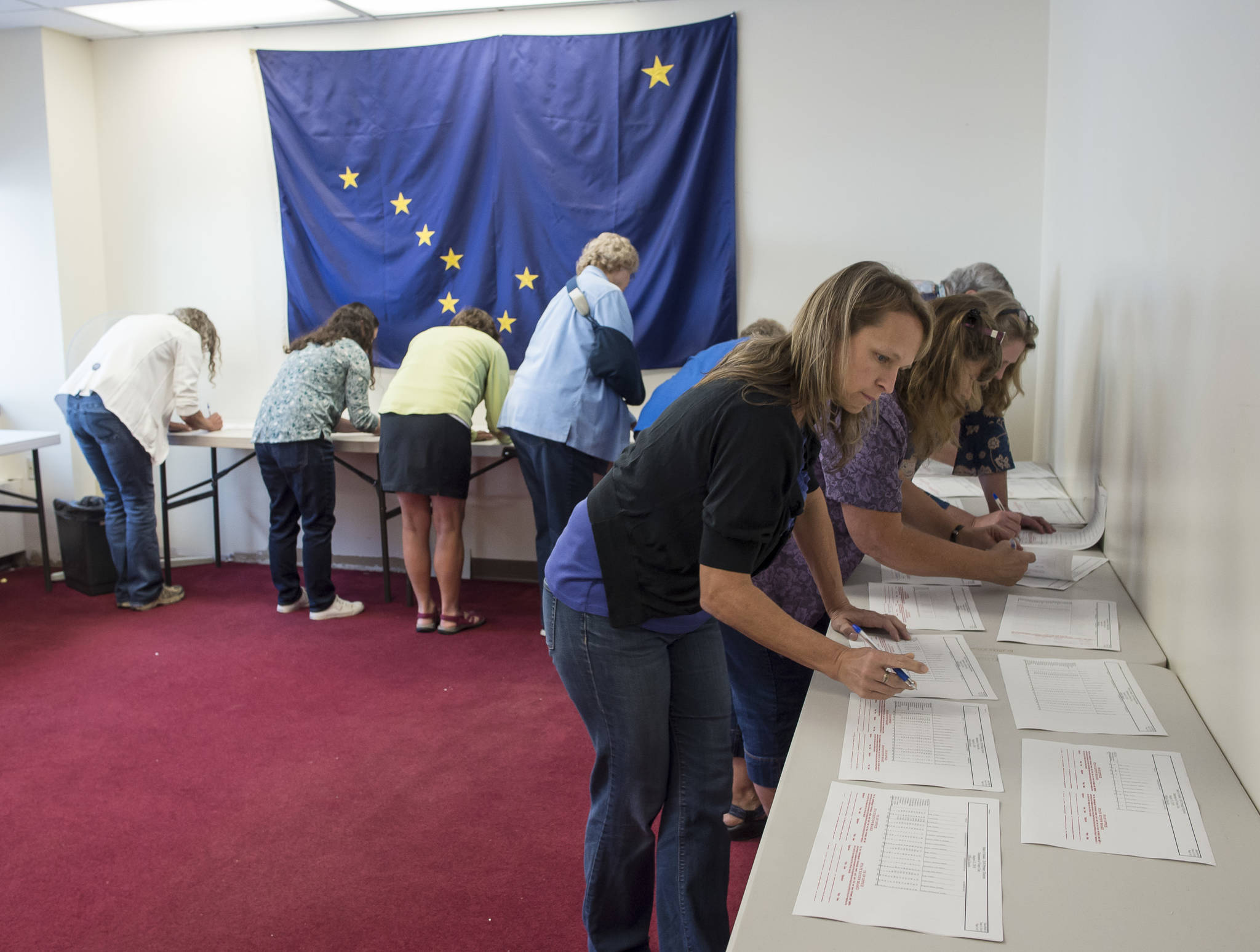 Alaska Review Board members sign the certifications of the state’s primany election at the state’s election office in downtown Juneau on Tuesday, Sept. 4, 2018. (Michael Penn | Juneau Empire)