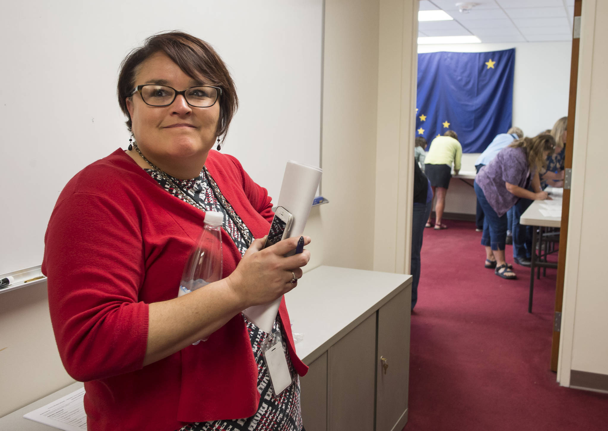 Josie Bahnke, State of Alaska’s Director of Elections, waits as Alaska Review Board members sign the final certifications of the state’s primany election at the state’s election office in downtown Juneau on Tuesday, Sept. 4, 2018. (Michael Penn | Juneau Empire)