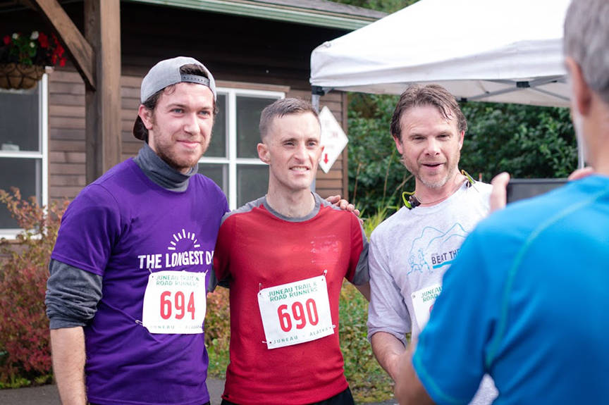 The winner of the Juneau Family Health and Birth Center Fun Run, Shawn Miller (center), poses for a picture with Georgi Dobrev (left), and Gus Marx (right) on Saturday outside the clinic on Hospital Drive. (Courtesy Photo | Madi Nolan)