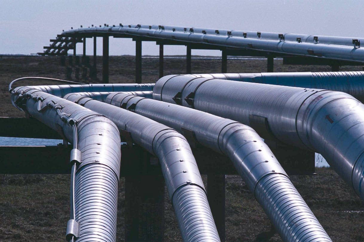 In this file photo from July 2001, pipes cross the tundra at the Alpine facility operated by Phillips Alaska. (Michael Penn | Juneau Empire File)