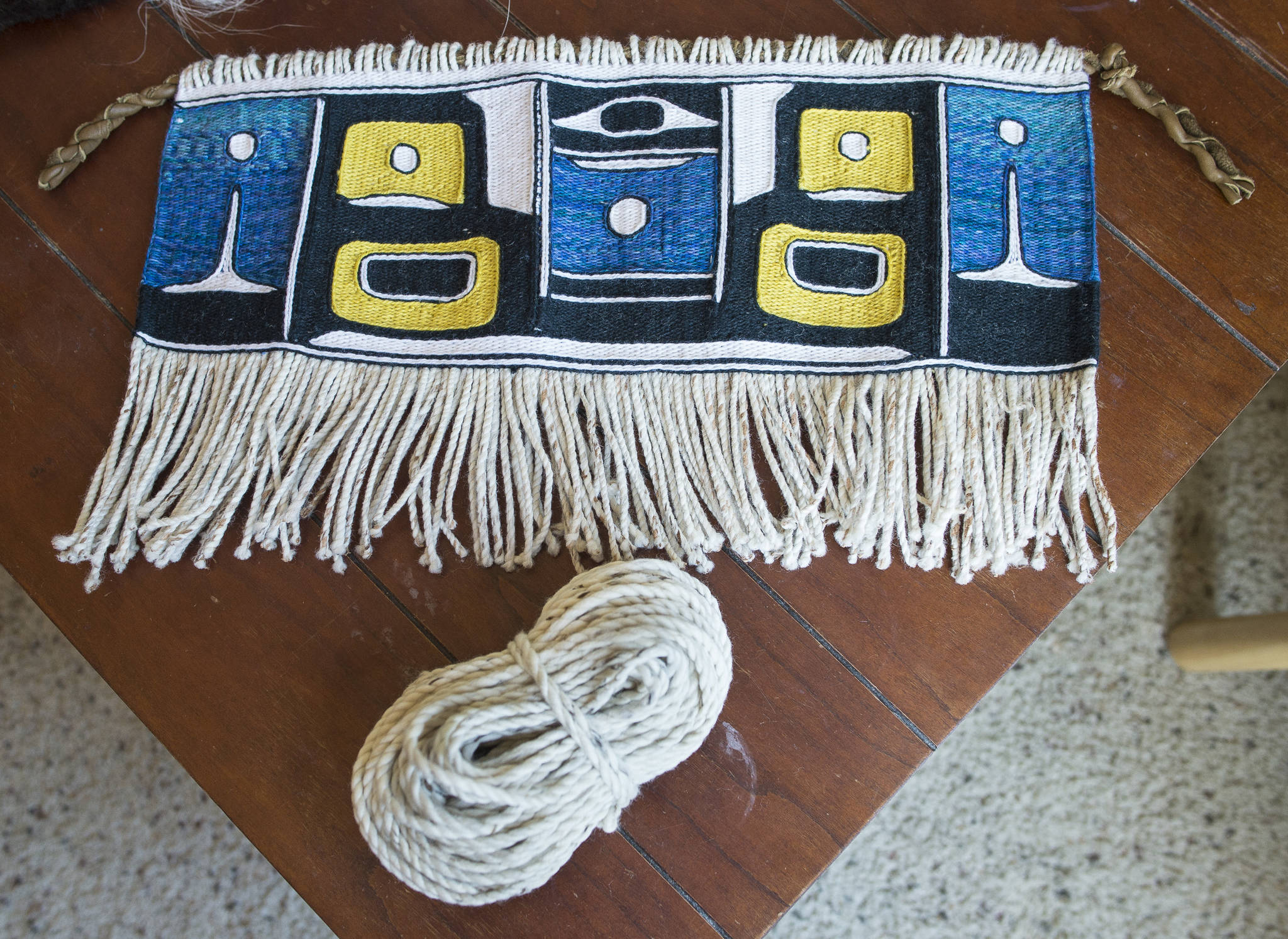 A finished Chilkat weaving and mountain goat wool warp by Juneau weaver Ricky Tagaban on Monday, Sept. 10, 2018. (Michael Penn | Juneau Empire)