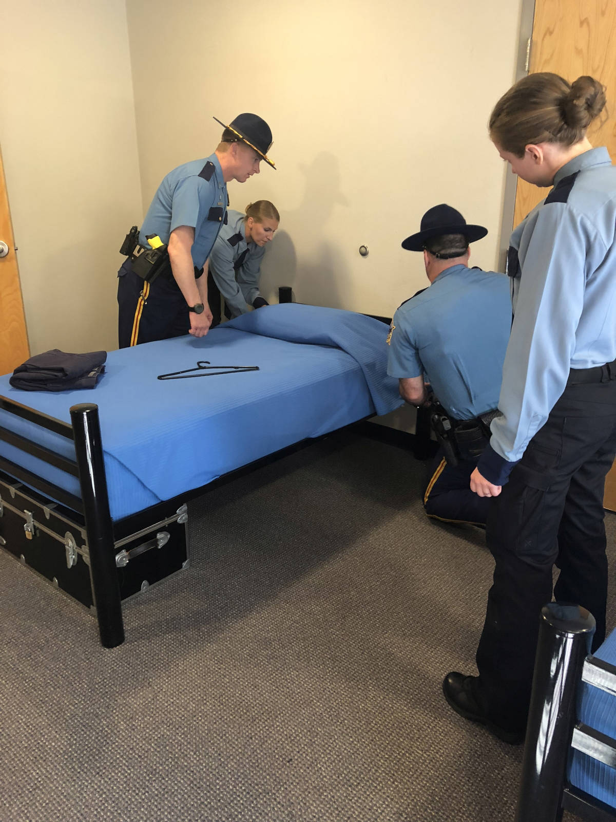 Alaska Law Enforcement Training Academy recruits are taught how to properly make the bed in their living quarters on July 30, 2018, the first day of training at the Public Safety Training Academy in Sitka, Alaska. (Alaska State Troopers photo)
