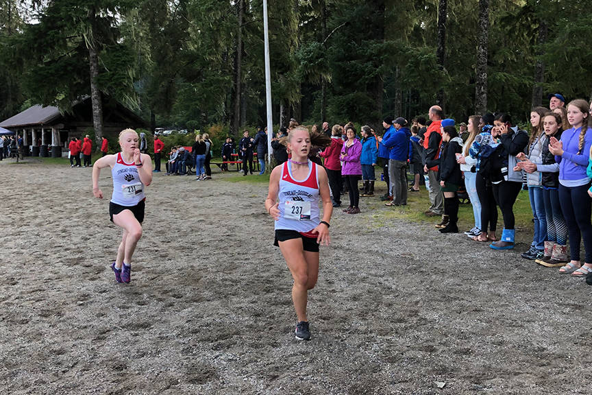 JDHS’ Gretchen Neal (left), and Marina Lloyd sprint to the finish line in Petersburg on Friday during the Petersburg Invitational cross country meet. (Courtesy Photo | Zack Bursell)