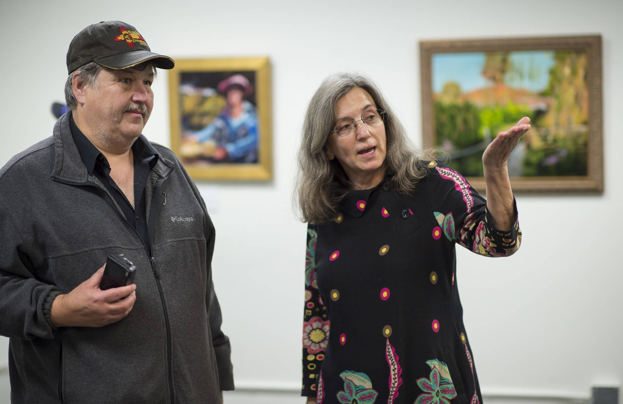Painter Magil Pratt tells Steve Winker about her work at the Juneau Arts & Culture Center during First Friday on Friday, Sept. 7, 2018. (Michael Penn | Juneau Empire)