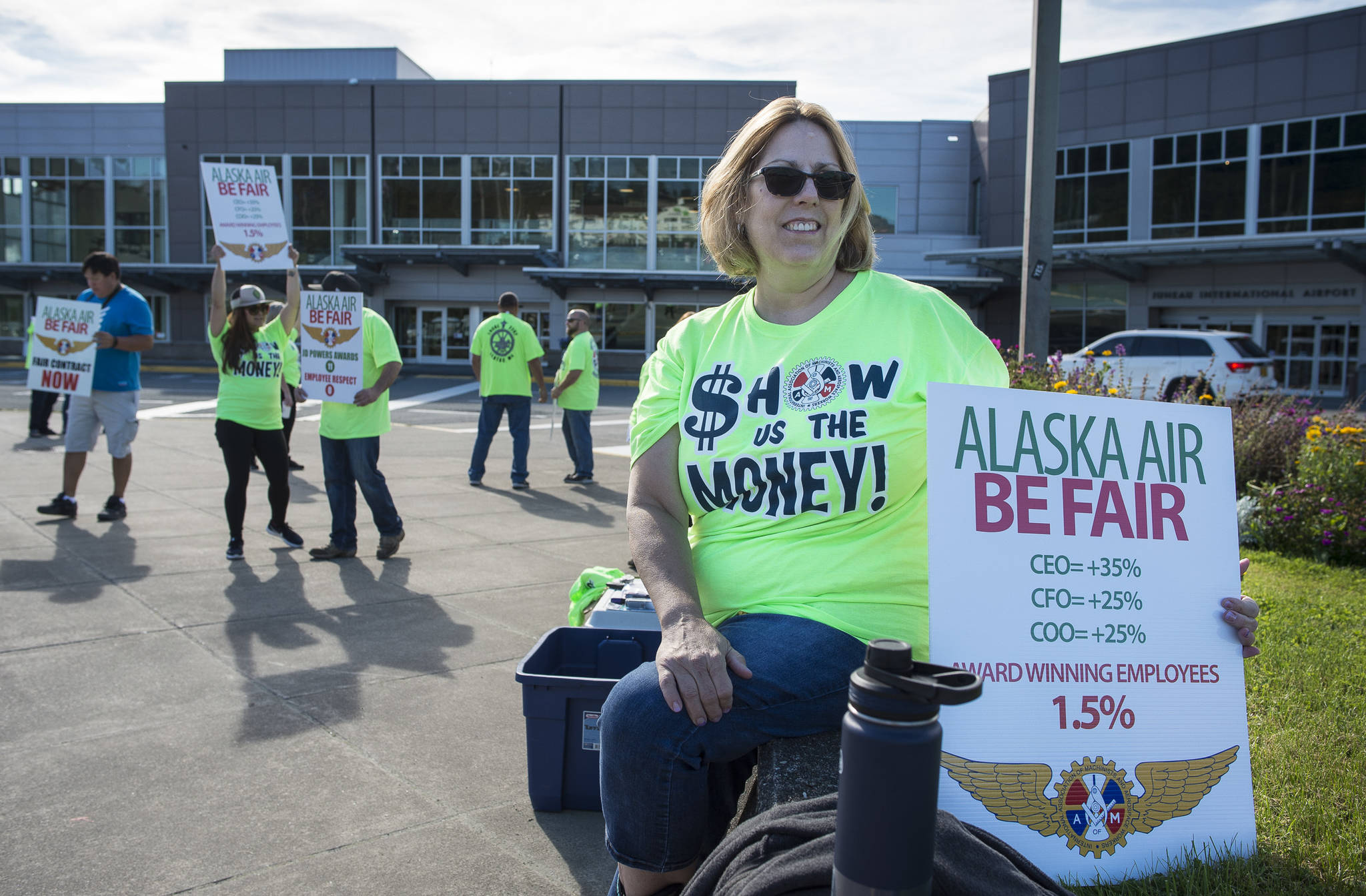 Mary Ann Breffeilh, a 20-year-employee of Alaska Airlines, joins other employees and members of the International Association of Machinists & Aerospace Workers Local 2202 to hold a protest on pay raises in front of the Juneau International Airport on Monday, Sept. 10, 2018. (Michael Penn | Juneau Empire)