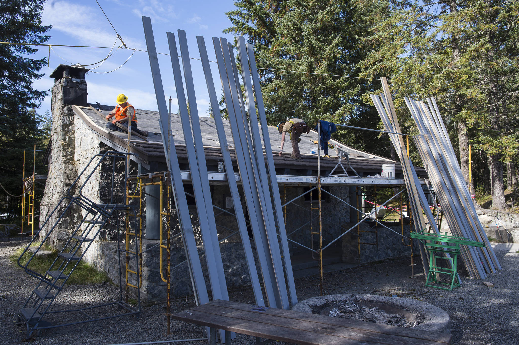 A U.S. Forest Service crew works to replace the nearly 30-year-old roof on the historic building of Skaters Cabin on Wednesday, Sept. 12, 2018. (Michael Penn | Juneau Empire)