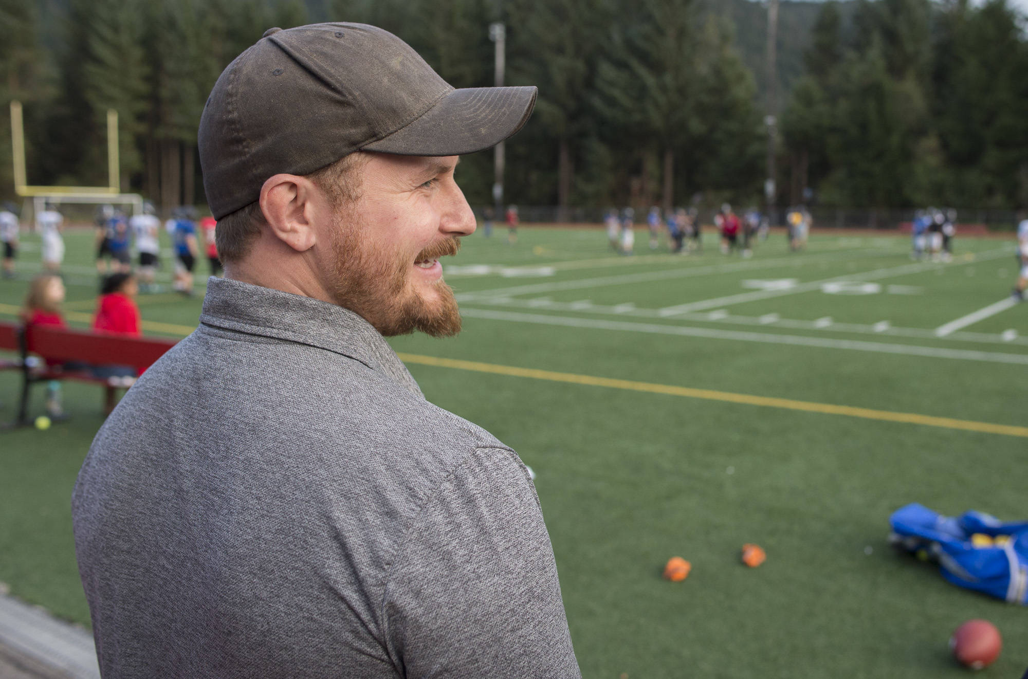 Certified athletic trainer Jake Ritter watches over Juneau United’s football practice at Adair-Kennedy Memorial Field on Wednesday. (Michael Penn | Juneau Empire)