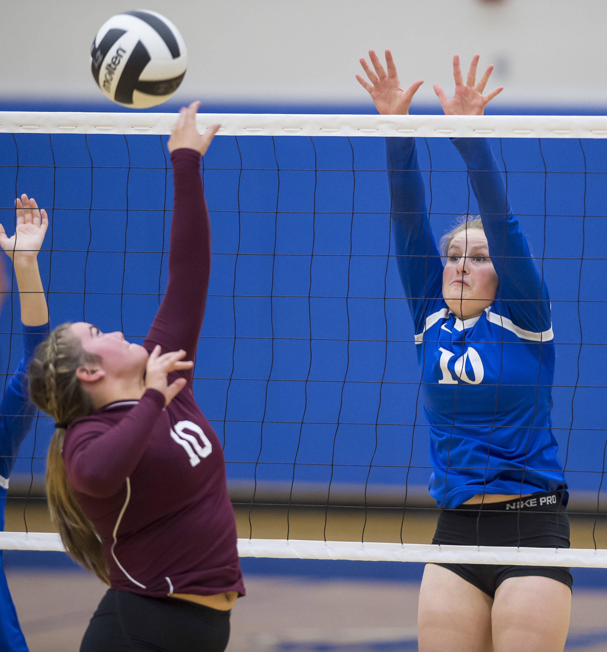 Thunder Mountain’s Audrey Welling attempts to block a shot by Ketchikan’s Makenzie Merrill at TMHS on Friday, Sept. 14, 2018. TMHS won 3-0. (Michael Penn | Juneau Empire)