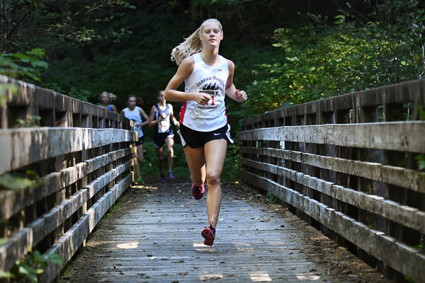 Juneau-Douglas junior Sadie Tuckwood takes the lead on Saturday during a Region V cross country meet at Ward Lake in Ketchikan. Tuckwood placed first in the girls race. (Dustin Safranek | Ketchikan Daily News)
