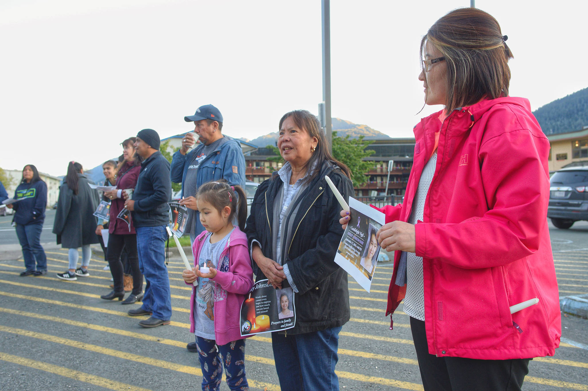 Melissa Jack, right, of Kotzebue, right, stands with her daughter, Ashlyn, and Dorothy Zura during a candlelight vigil for Ashley Johnson-Barr on Monday, Sept. 17, 2018. (Michael Penn | Juneau Empire)