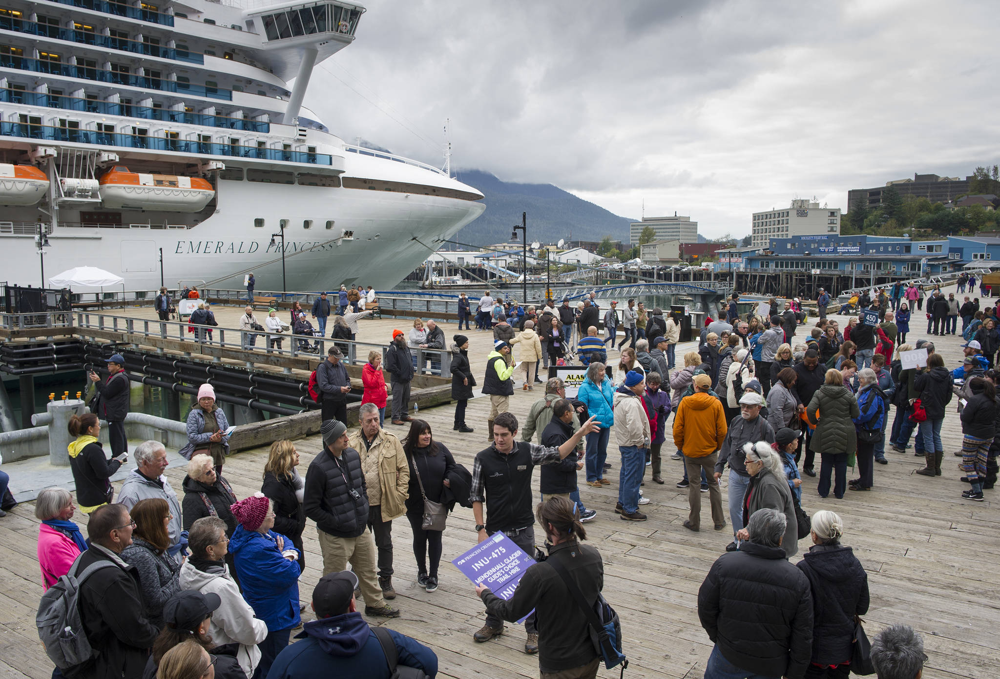Cruise ship visitors gather for their tours on the Seawalk on Wednesday, Sept. 13, 2017. (Michael Penn | Juneau Empire File)