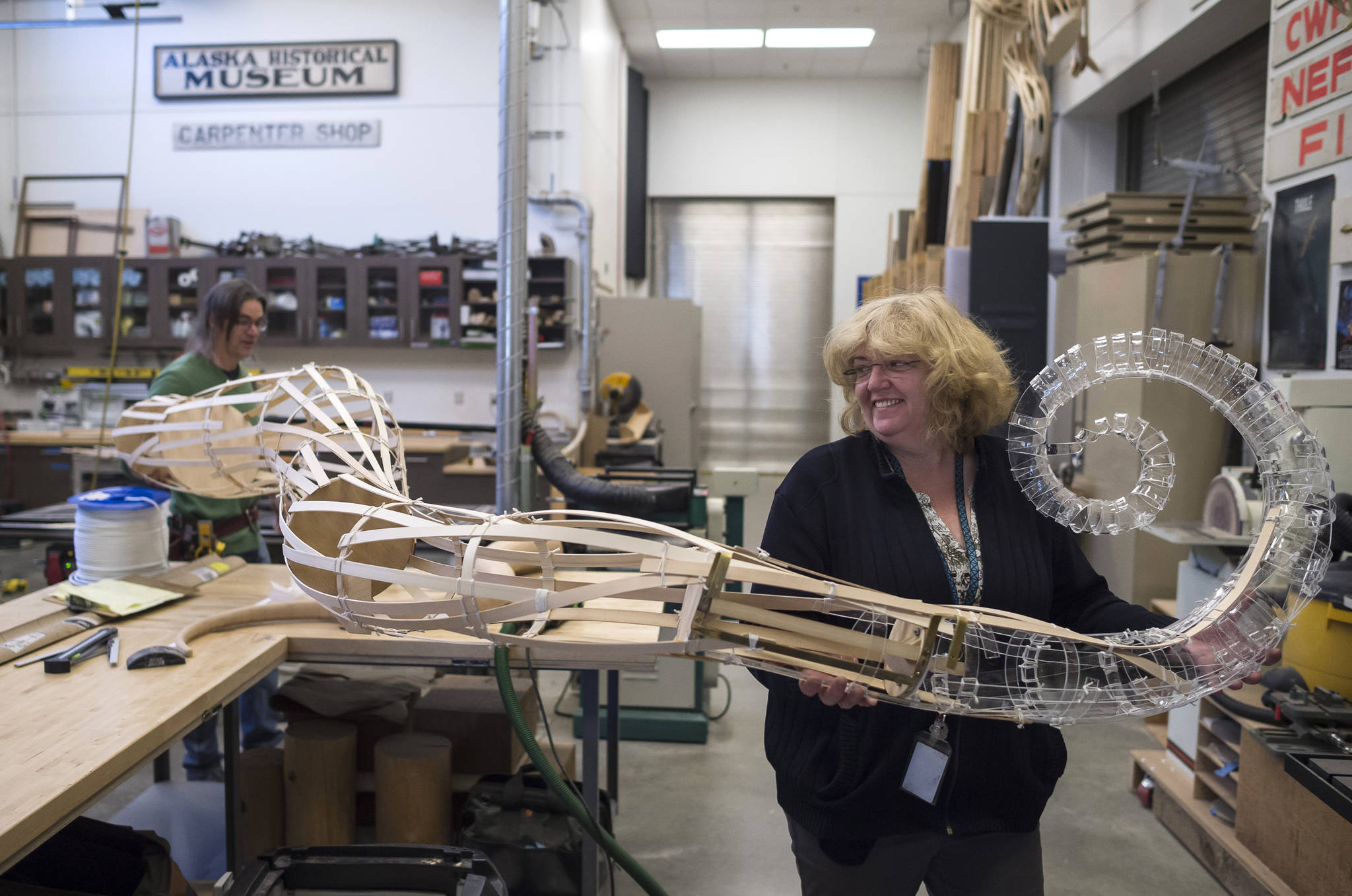 Alaska State Libraries, Archives and Museums Operation Manager Lisa Golisek-Nankerv, right, helps Museum Exhibit Specialist Aaron Elmore move one of the eight legs to a giant octopus he is building for the Museum’s children’s room on Monday, Sept. 17, 2018. (Michael Penn | Capital City Weekly)