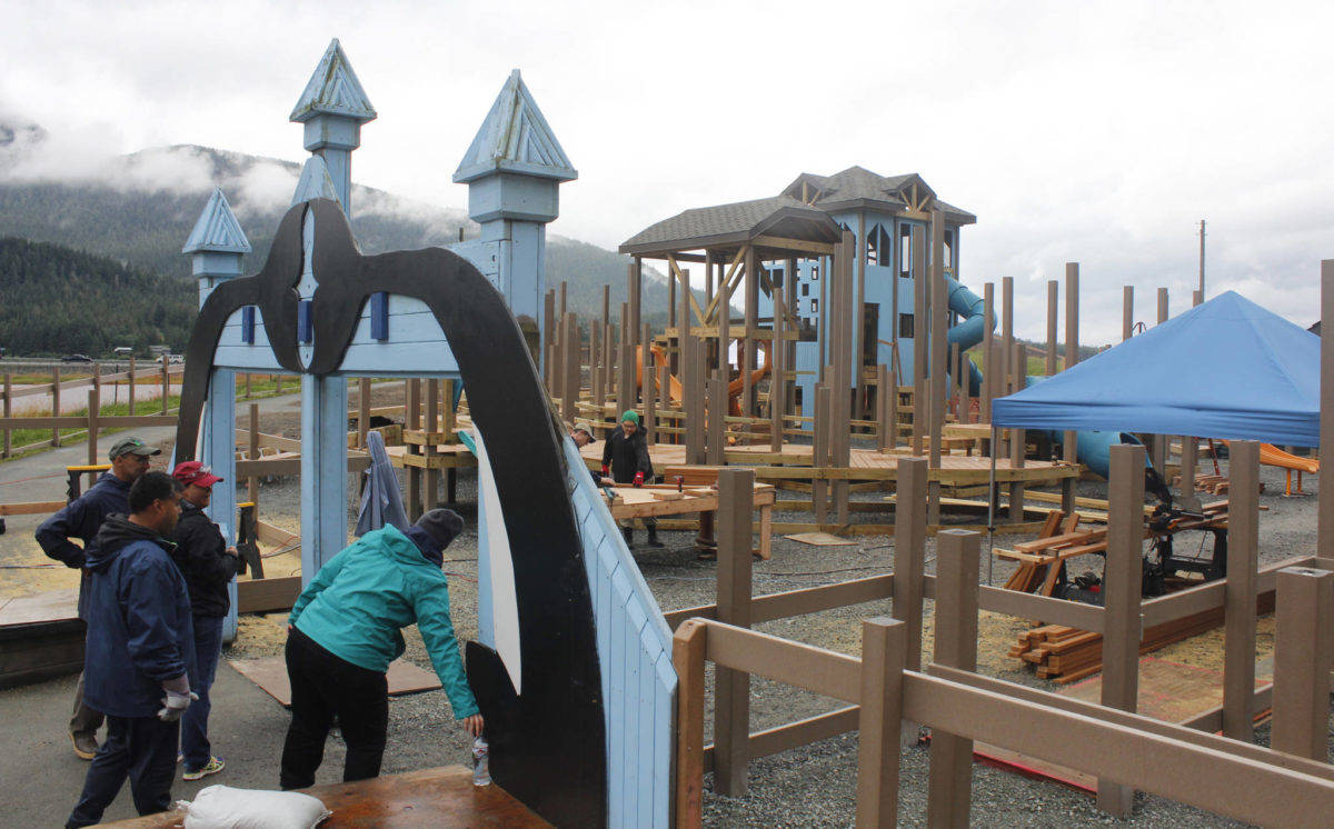 Volunteers gather at the arch of Project Playground during the first day of the community rebuilt, Aug. 8, 2018. (Alex McCarthy | Juneau Empire)