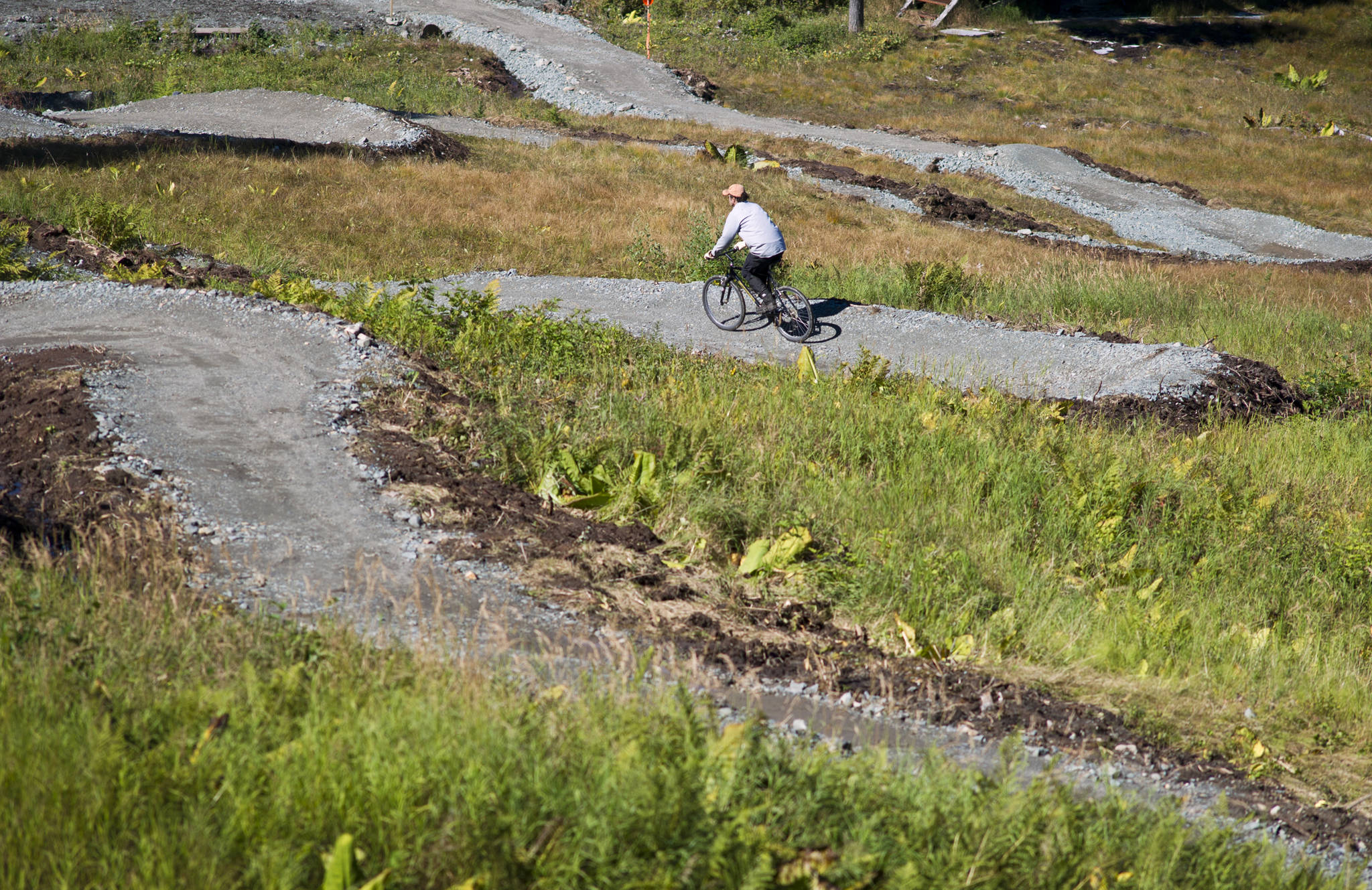 Ron Flint takes a ride on the completed lower section of a mountain bike trail at the Eaglecrest Ski Area August 2015. Volunteers with the Juneau Freewheelers Cycle Club and Eaglecrest staff worked on the downhill trail. (Michael Penn | Juneau Empire)