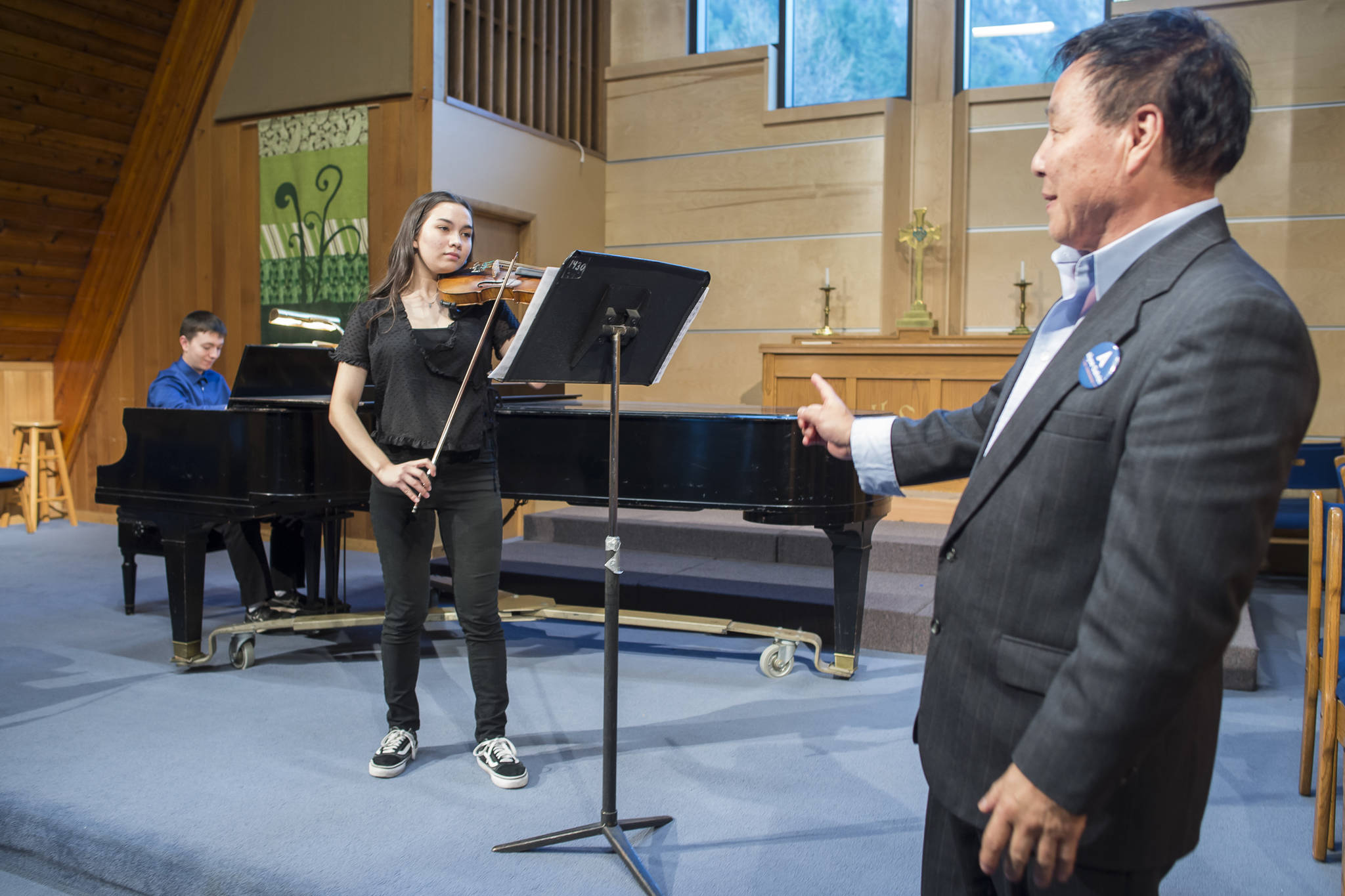 Violin instructor Guo Hua Xia, right, listens as violinist Lisa Eldridge and pianist Kyle Farley-Robinson practice their recital piece at Northern Light United Church on Friday, Sept. 21, 2018. (Michael Penn | Juneau)