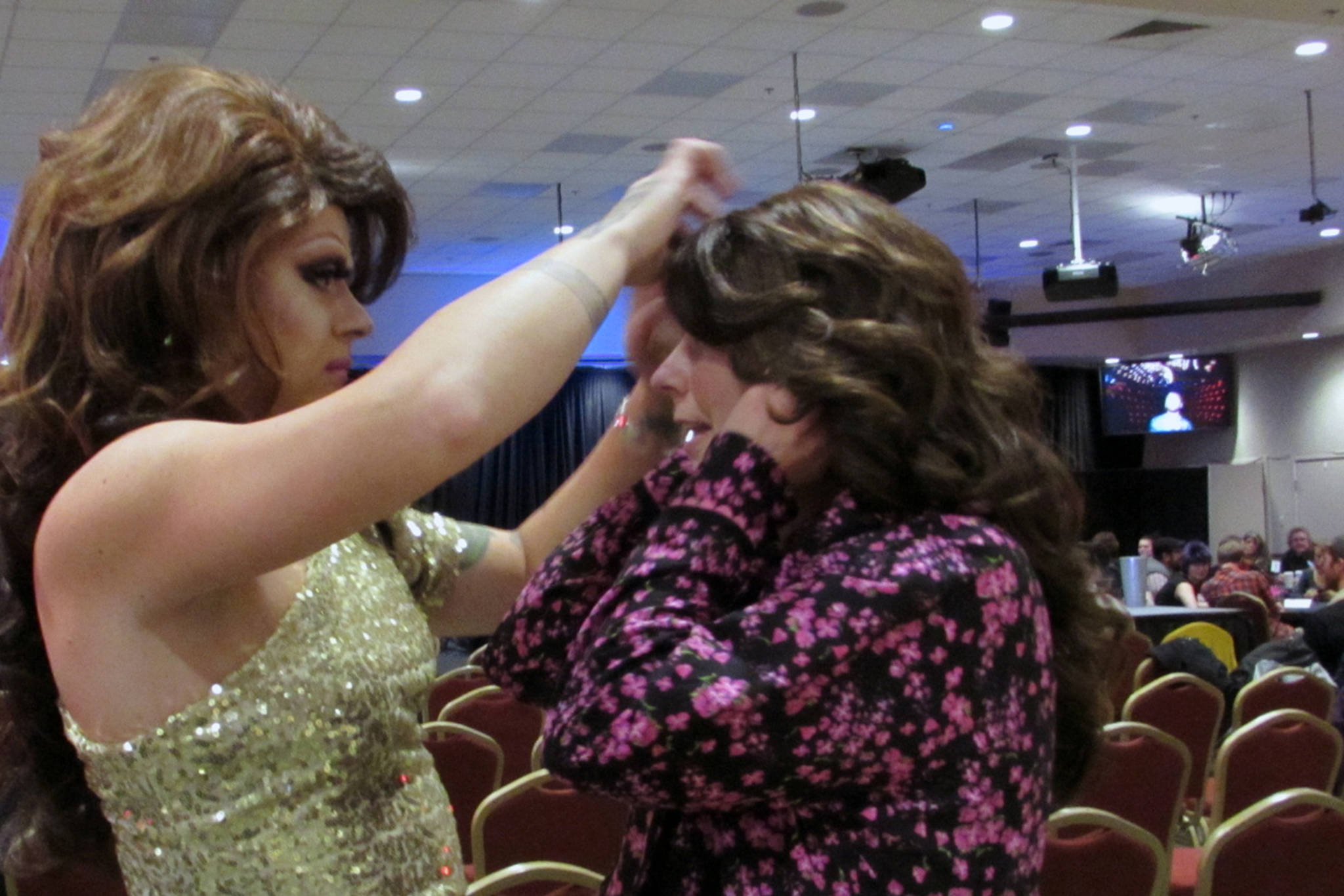 Drag queen Lituya Hart helps Mary Folletti Cruise swap out her black cap for a wig before the Besties for Breasties drag show, which benefitted Folletti Cruise. Folletti Cruise said she was impressed by the community support she has received since her breast-cancer diagnosis. (Ben Hohenstatt | Capital City Weekly)