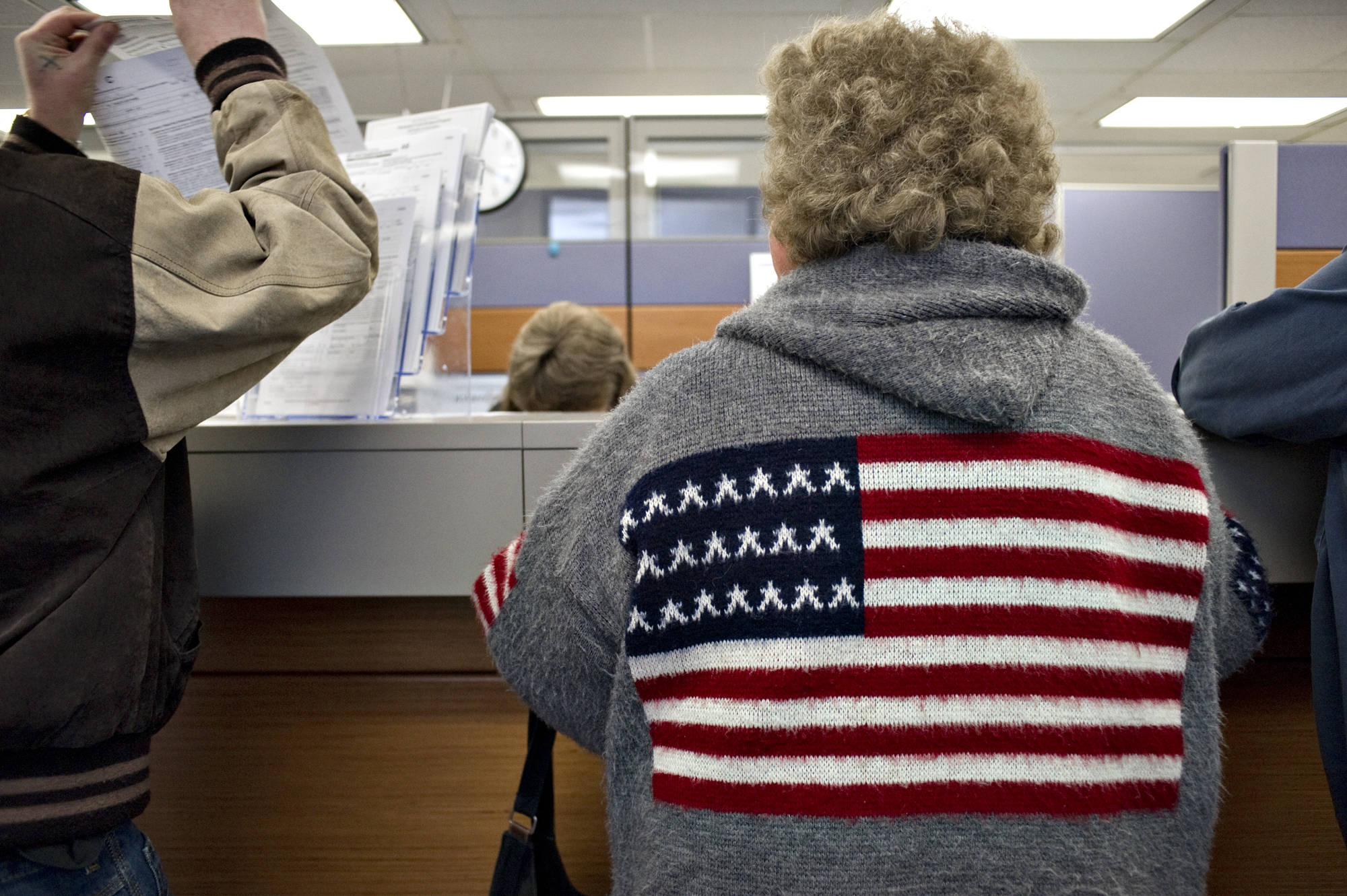 Alaskans pick up and turn in Permanent Fund Dividend applications at the Department of Revenue office in the State Office Building in March 2011. (Michael Penn | Juneau Empire)