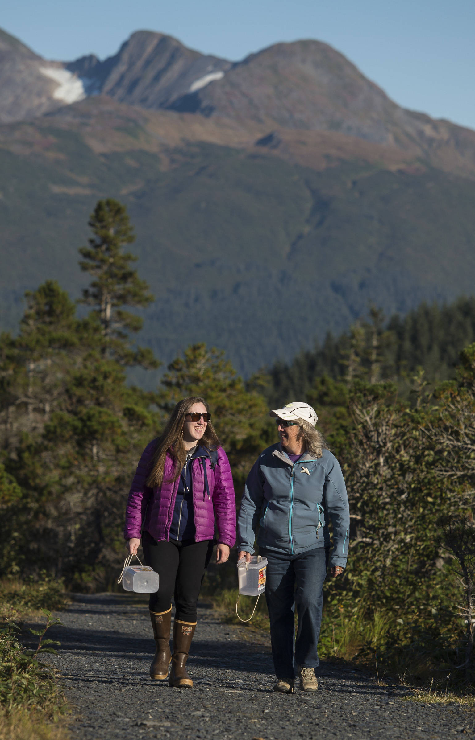 Erin Anais Heist, left, and her mother, Kate Troll, walk to pick high-bush cranberries on Douglas Island on Thursday, Sept. 20, 2018. (Michael Penn | Juneau Empire)