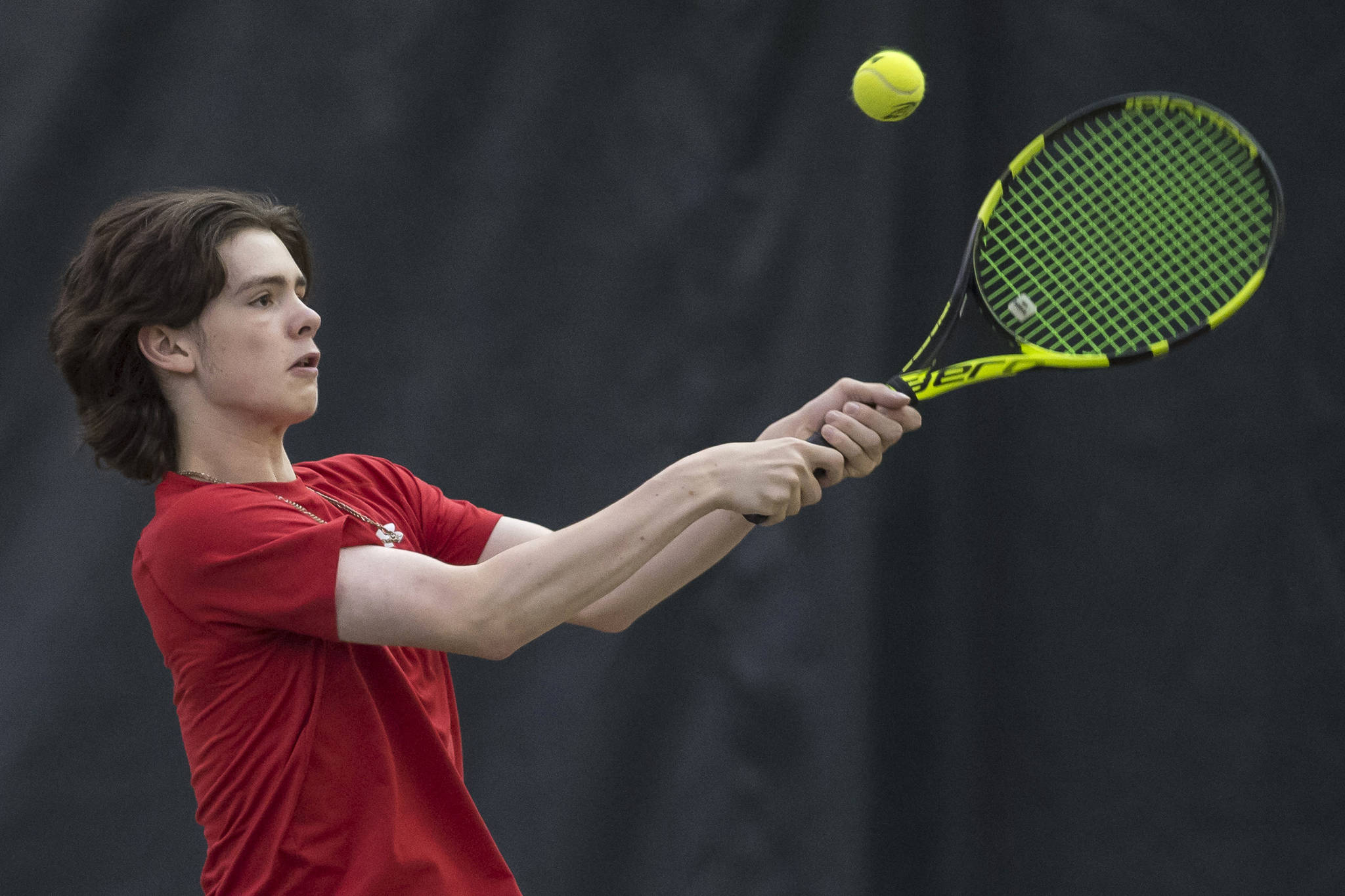 William Smoker, a junior at Juneau-Douglas High School, returns a backhand during the Regional Tennis Championships at JRC/The Alaska Club on Sunday, Sept. 23, 2018. Smoker placed first in singles, doubles and mixed doubles. (Michael Penn | Juneau Empire)