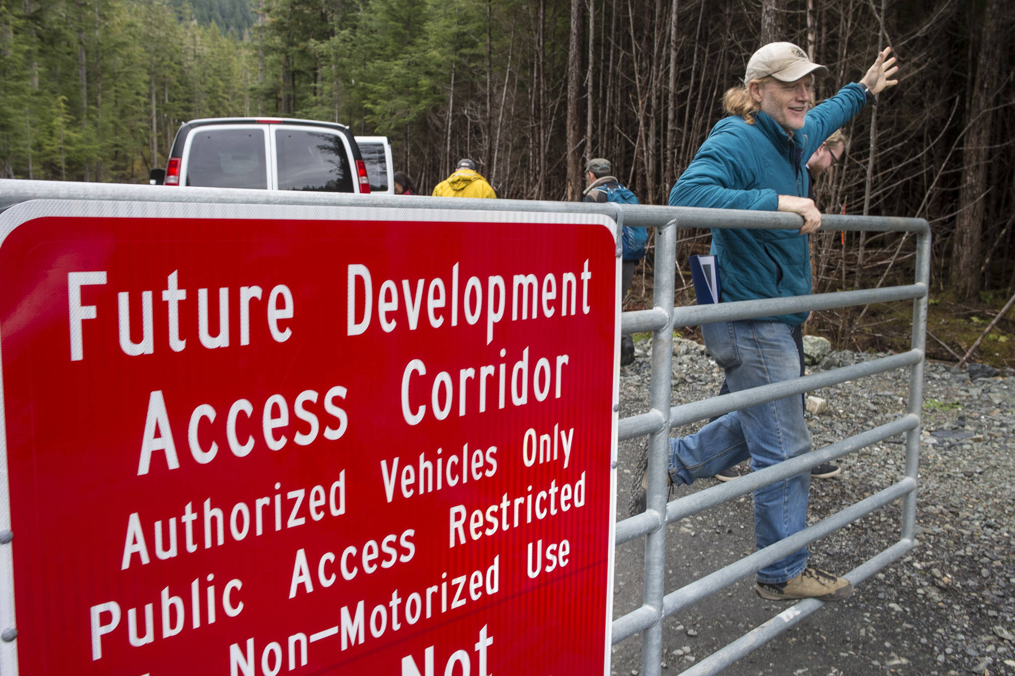 Alan Steffert, project manager for the city, closes the gate to the West Douglas Pioneer Road after a ribbon cutting ceremony to officially open the West Douglas Pioneer Road on Friday, Sept. 28, 2018. (Michael Penn | Juneau Empire)
