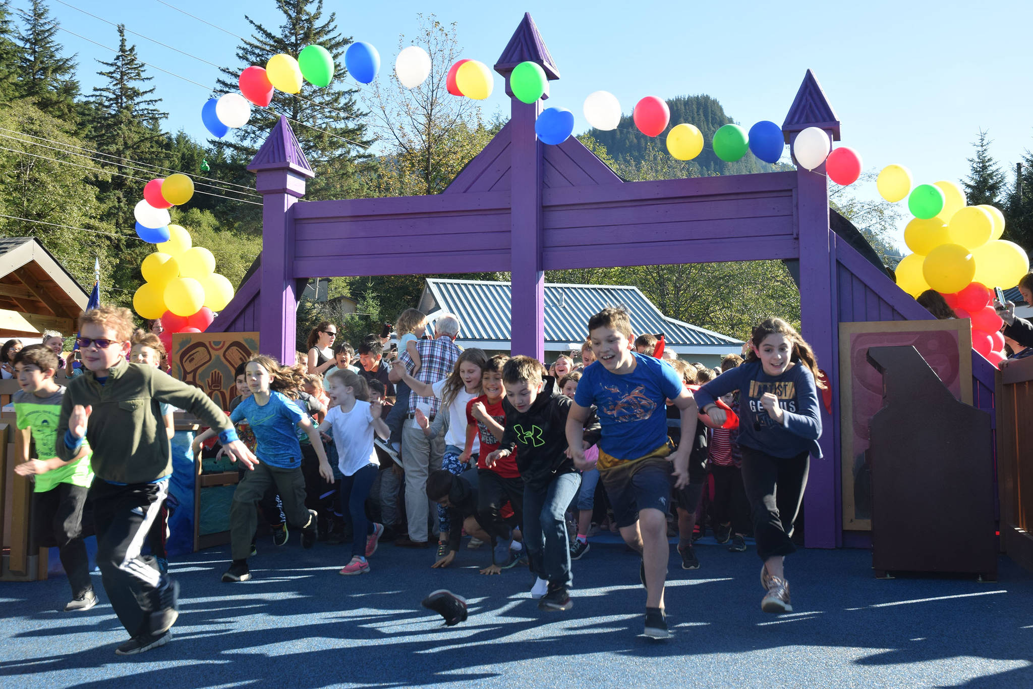 Children run into Project Playground during a grand reopening at Twin Lakes on Saturday, Sept. 29, 2018. (Kevin Gullufsen | Juneau Empire)