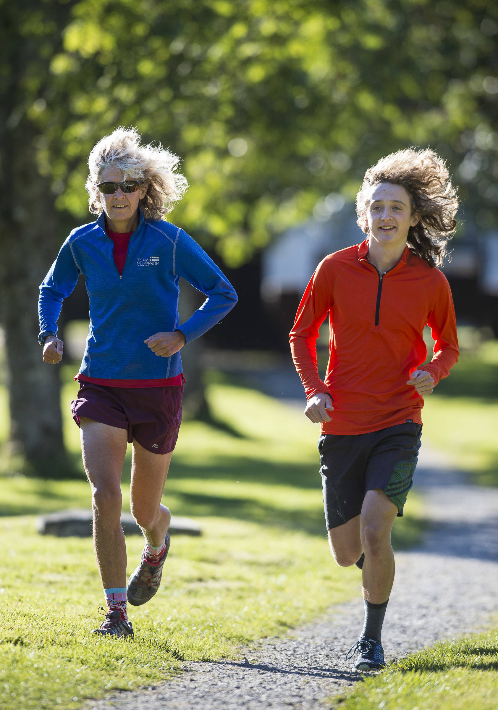Merry Ellefson runs with her son, Arne Ellefson-Carnes, during Juneau-Douglas High School cross country practice on Wednesday, Sept. 19, 2018. Merry is a co-coach for the team and Arne is a senior. (Michael Penn | Juneau Empire)