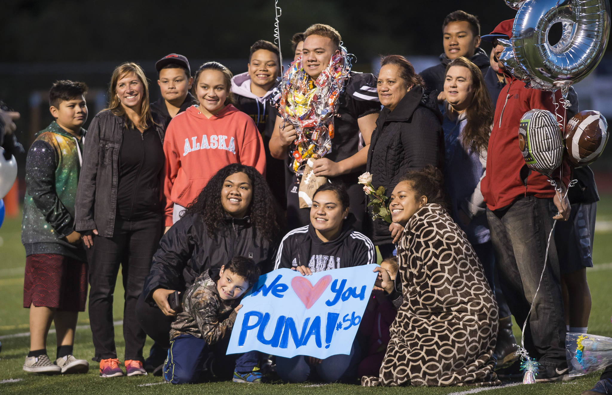 Family and friends celebrate senior Puna Toutaiolepo before Juneau United’s game against Colony at Thunder Mountain High School on Friday, Sept. 21, 2018. (Michael Penn | Juneau Empire)