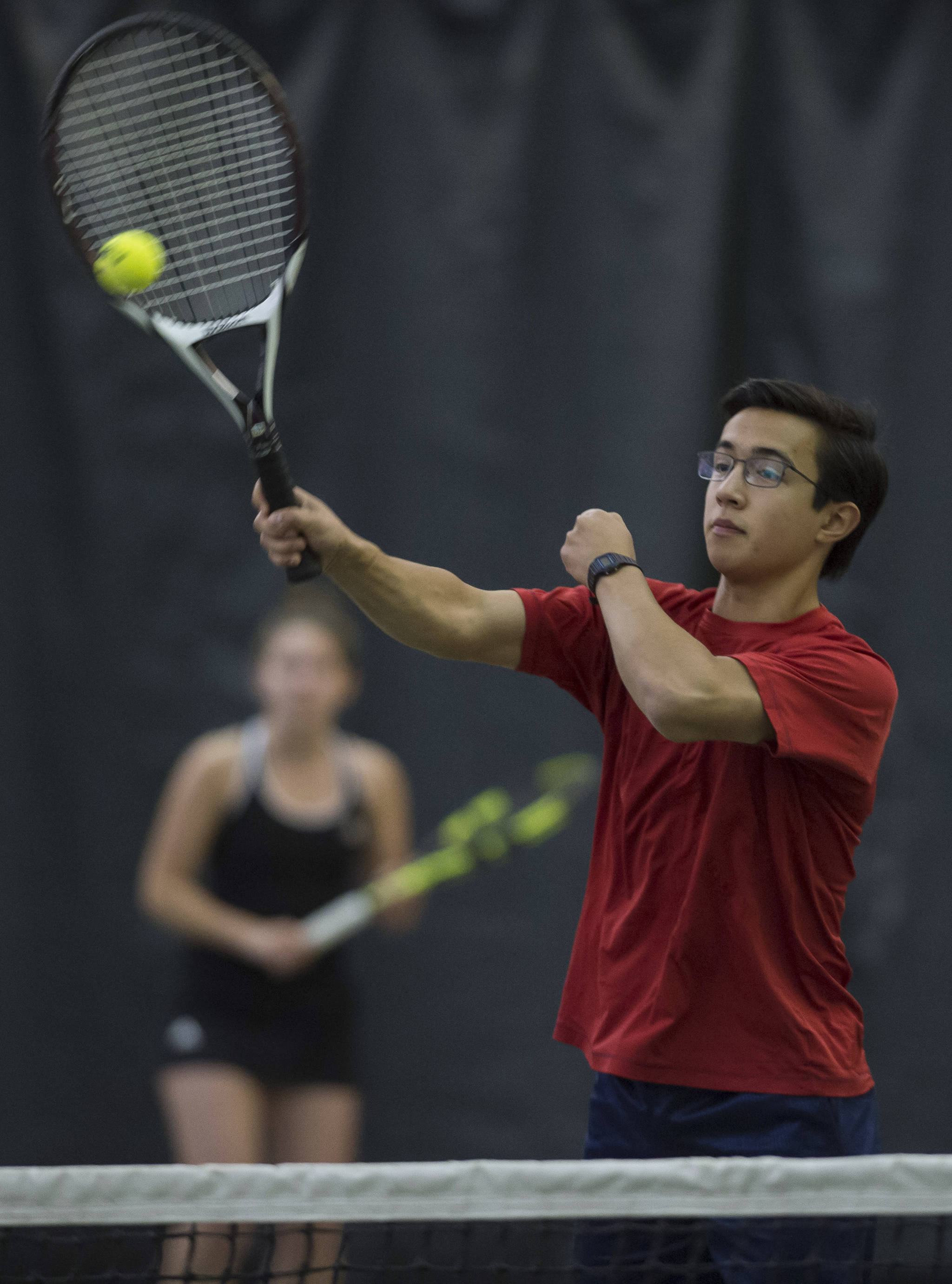 River Reyes-Boyles volleys a ball against the team of and Adelie McMillan and Wolf Dostal during the Regional Tennis Championships at the JRC/The Alaska Club on Saturday, Sept. 22, 2018. Reyes_Boyles is backed up by partner Jaymie Collman, background, in the mixed double match. (Michael Penn | Juneau Empire)
