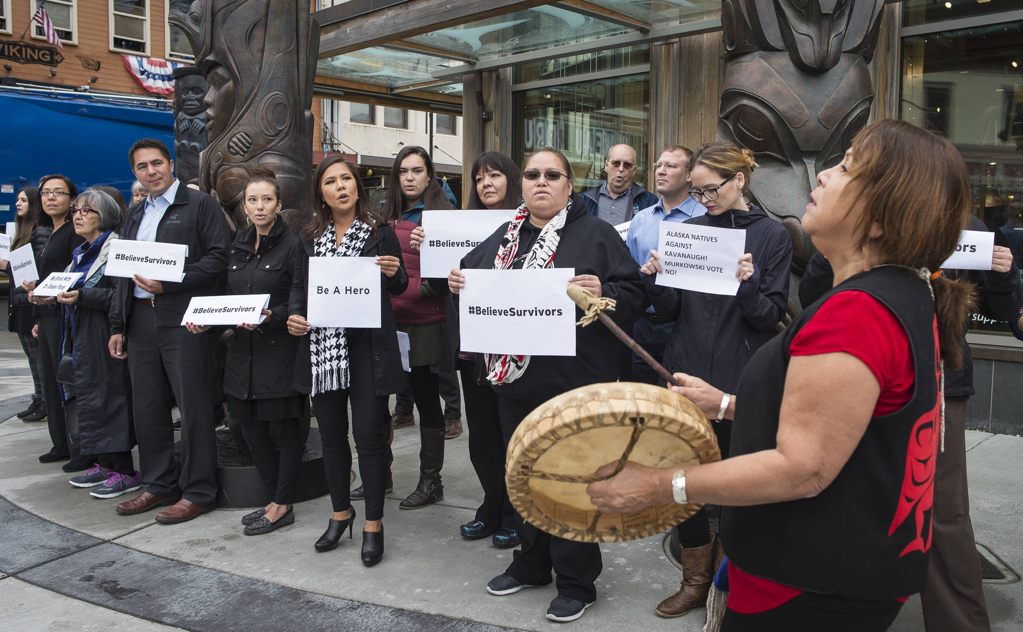 Nancy Barnes drums as about 30 people from the Walter Soboleff Center and Sealaska Corporation stand Monday, Sept. 24, 2018, in support of victims of sexual violence. The National Walk Out was in support of Dr. Christine Blasey Ford and Deborah Ramirez in their statements of being sexually assaulted by Supreme Court nominee Brett Kavanaugh decades ago. Supporters were asked to dress in black and photograph themselves for social media using #BelieveSurvivors at 1 p.m. Eastern Time on Wednesday. (Michael Penn | Juneau Empire)