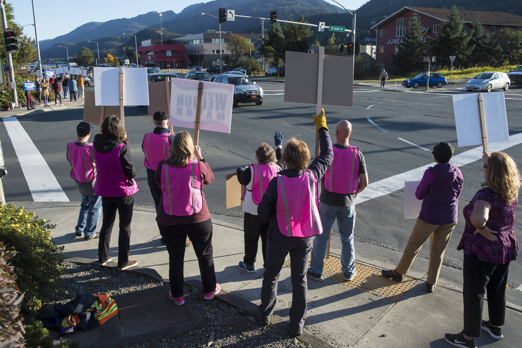 Supporters for mayoral candidates Beth Weldon, Saralyn Tabachnick and Assembly candidate Michelle Bonnet Hale wave signs at the corner of 10th Street and Egan Drive on Monday, Oct. 1, 2018, to remind drivers to vote in the Municipal Election Tuesday. (Michael Penn | Juneau Empire)