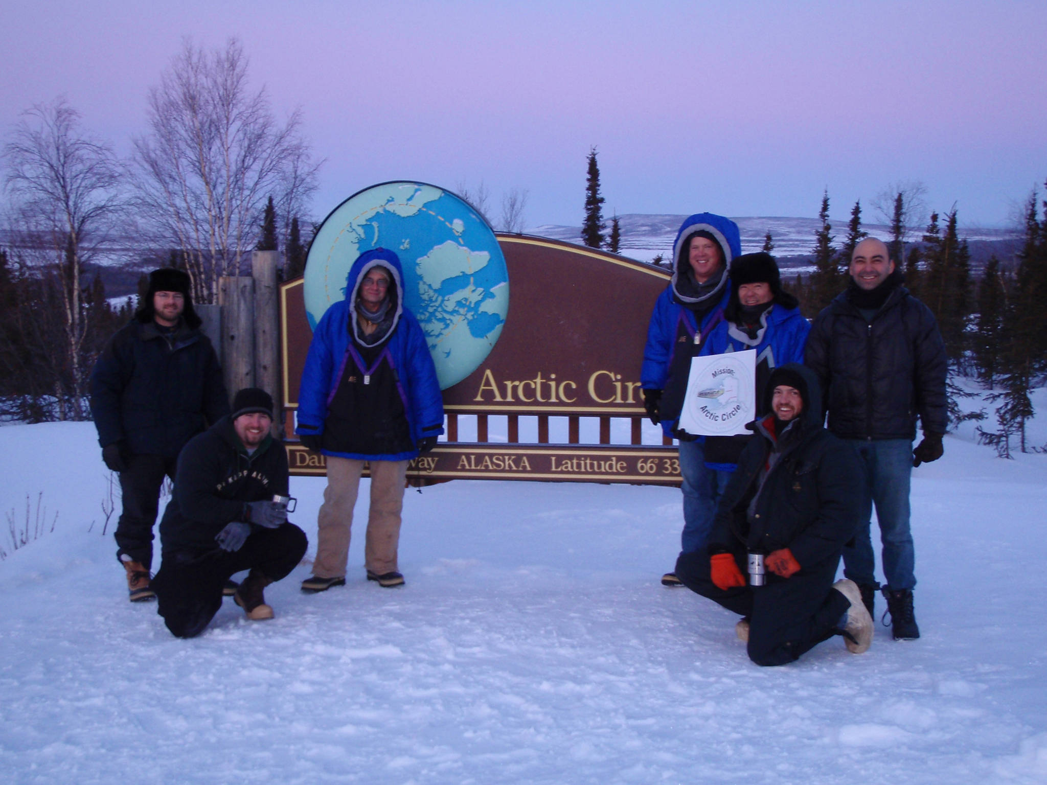 From left, Ryan West, Shawn Freitas, John Whittington, Doug Morrow, Bernie Tao, Darrin Marshall, and Andy Soria pose at the Arctic Circle pull-out on the Dalton Highway, where they camped in March 2009 to test the cold-weather performance of “Permaflo Biodiesel.” (Darrin Marshall | Courtesy photo)
