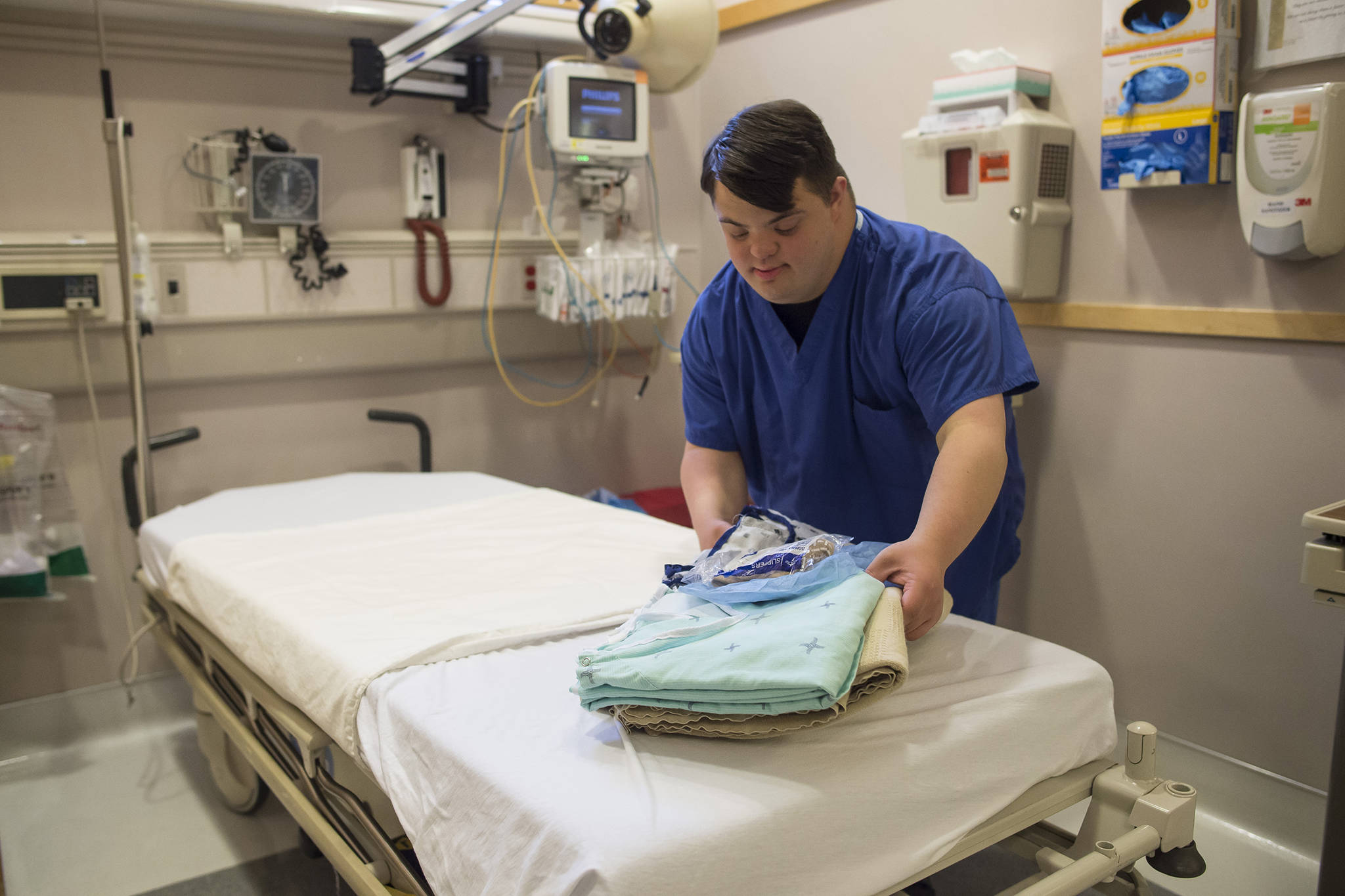 Solomon Dunlap cleans and makes up beds in the day surgery department as part of his internship at Bartlett Regional Hospital on Friday, Oct. 5, 2018. (Michael Penn | Juneau Empire)