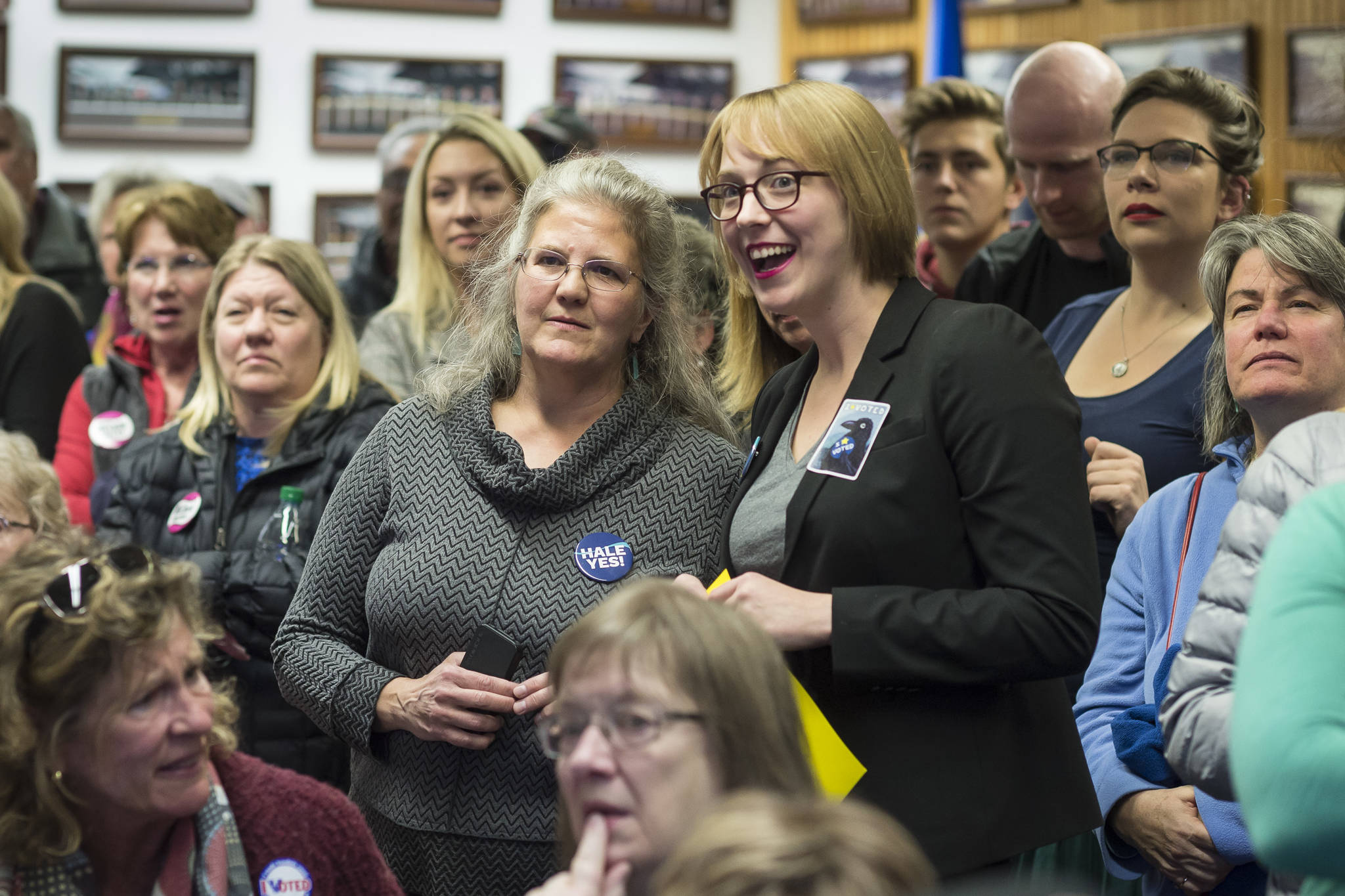 Assembly District 2 candidate Michelle Bonnet Hale, left center, and Assembly Areawide candidate Carole Triem watch their numbers soar as they watch Election results come in at the Assembly chambers on Tuesday, Oct. 2, 2018. (Michael Penn | Juneau Empire)