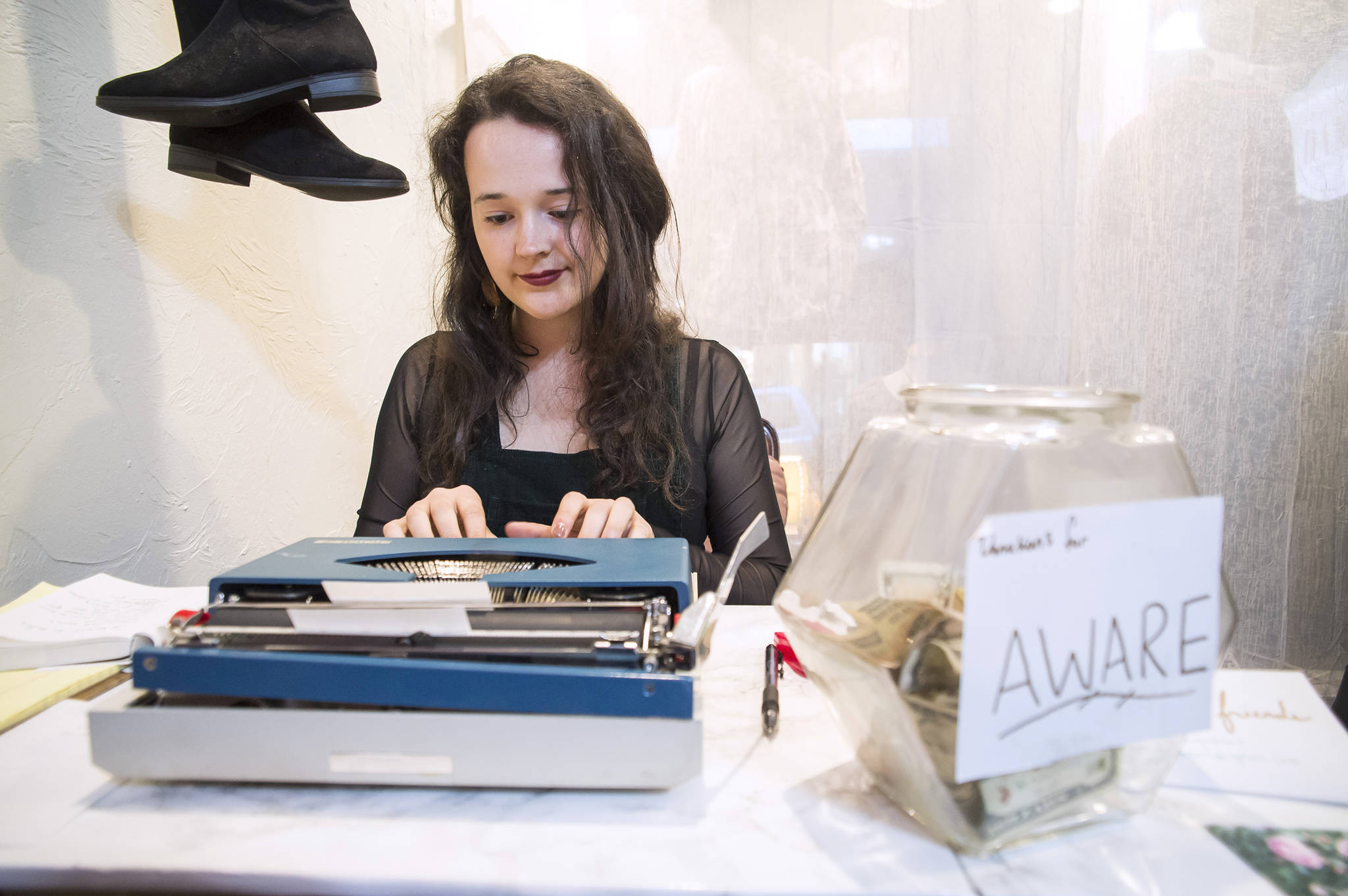 Audrey Kohler types out a poem for a patron at Downtown Dames during First Friday on Friday, Oct. 5, 2018. Kohler’s poems were written on the spot and based on suggestions from strangers. Kohler typed them on her grandmother’s old typewriter, so patrons received a keepsake. (Michael Penn, Juneau Empire)