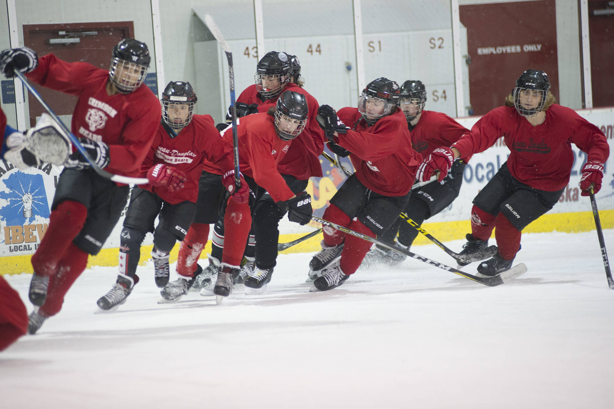 Juneau-Douglas High School teammates skate at top speed at the end of practice on Wednesday morning at Treadwell Arena. Wednesday was the first practice of the season. (Nolin Ainsworth | Juneau Empire)