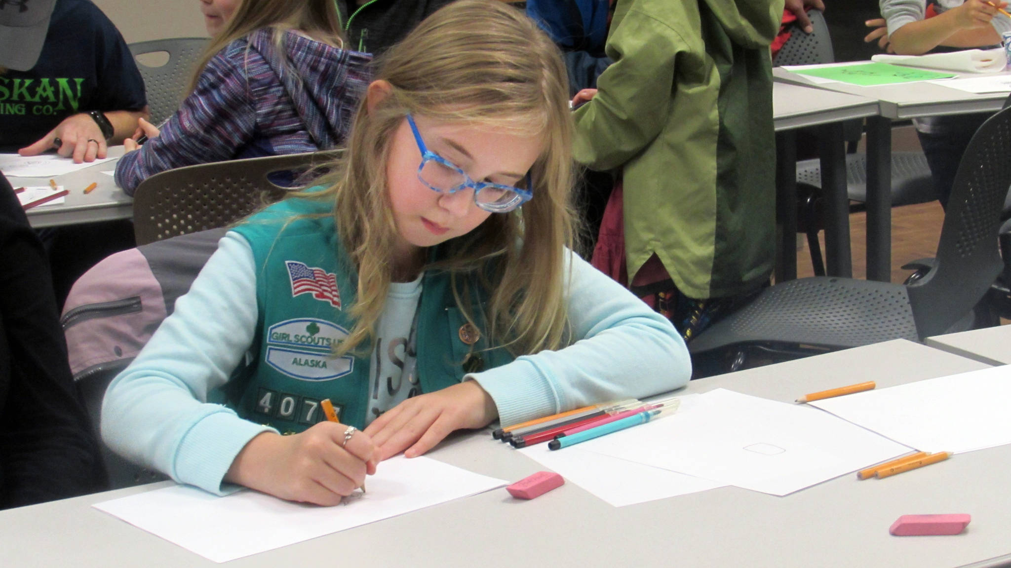 Farrah Fremlin, 8, said she finds coloring calming during a How to Make a Monster workshop with artist Glo Rameriz Saturday afternoon at Douglas Public Library. (Ben Hohenstatt | Capital City Weekly)