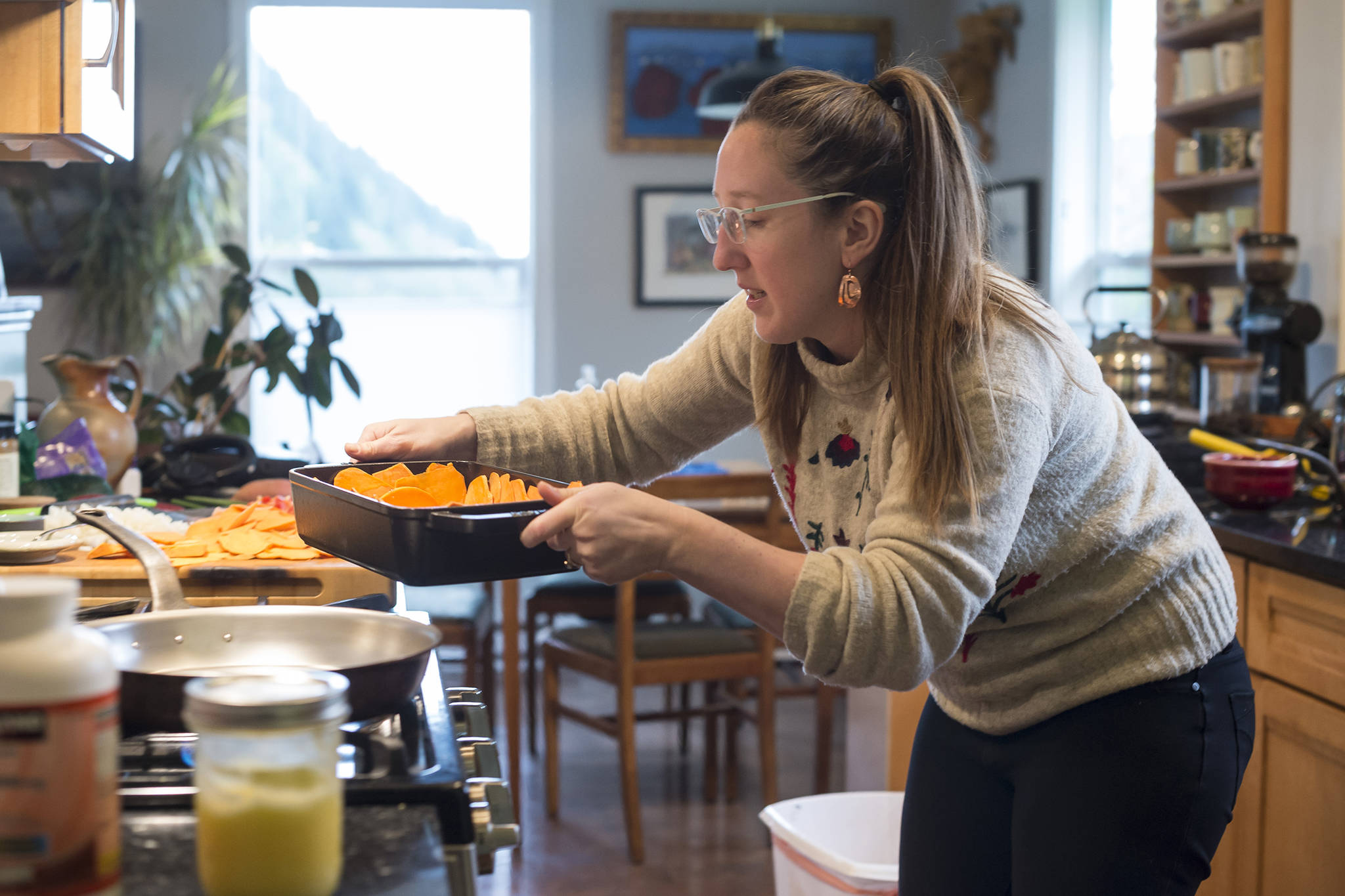 Erin Anais Heist fixes a sweet potato and salmon quiche in her home kitchen on Thursday, Oct. 4, 2018. (Michael Penn | Juneau Empire)