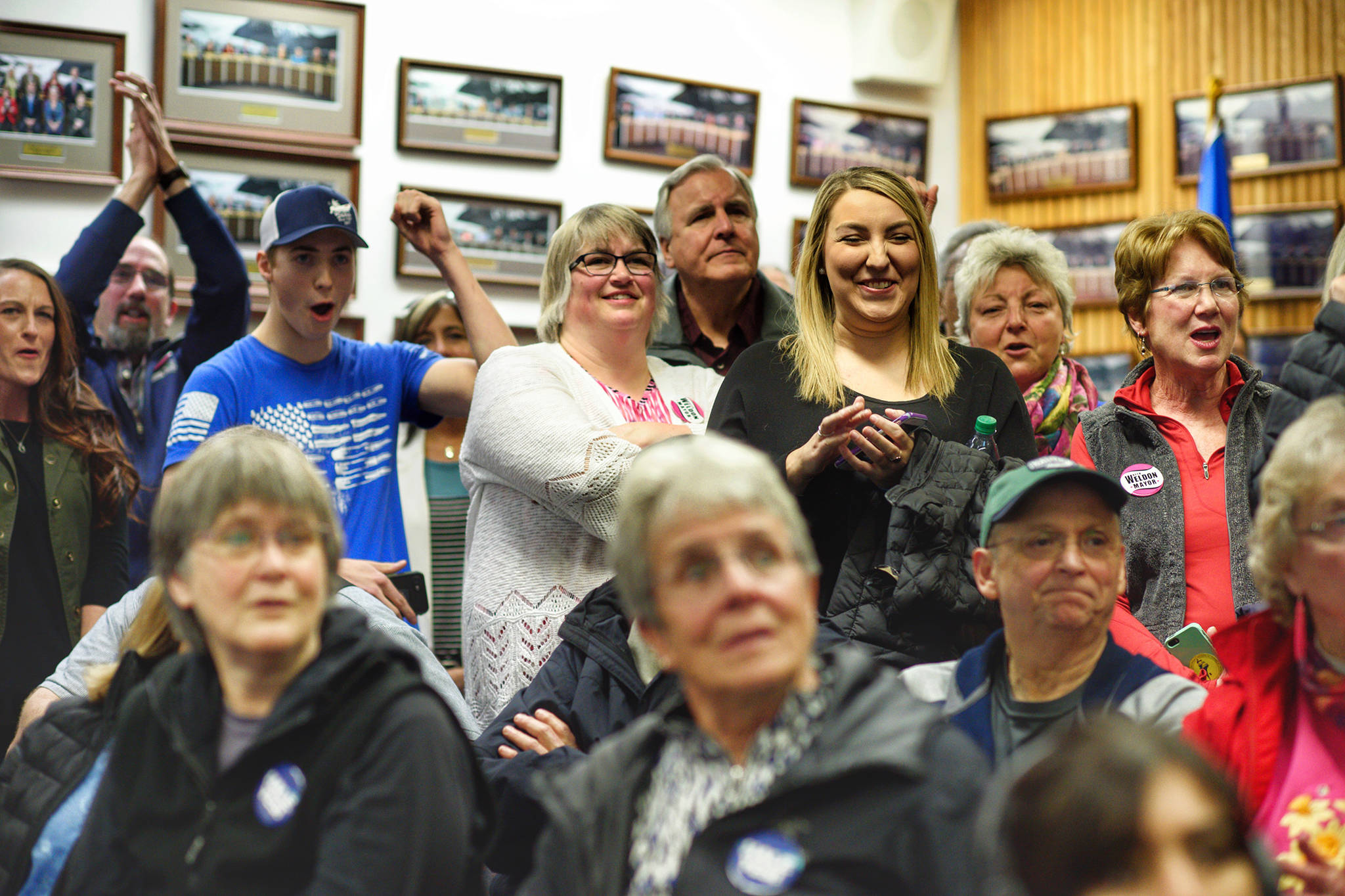 Beth Weldon and supports react to a lead in the polls as results came in live at Election Central at City Hall on Oct. 2, 2018. (Michael Penn | Juneau Empire)