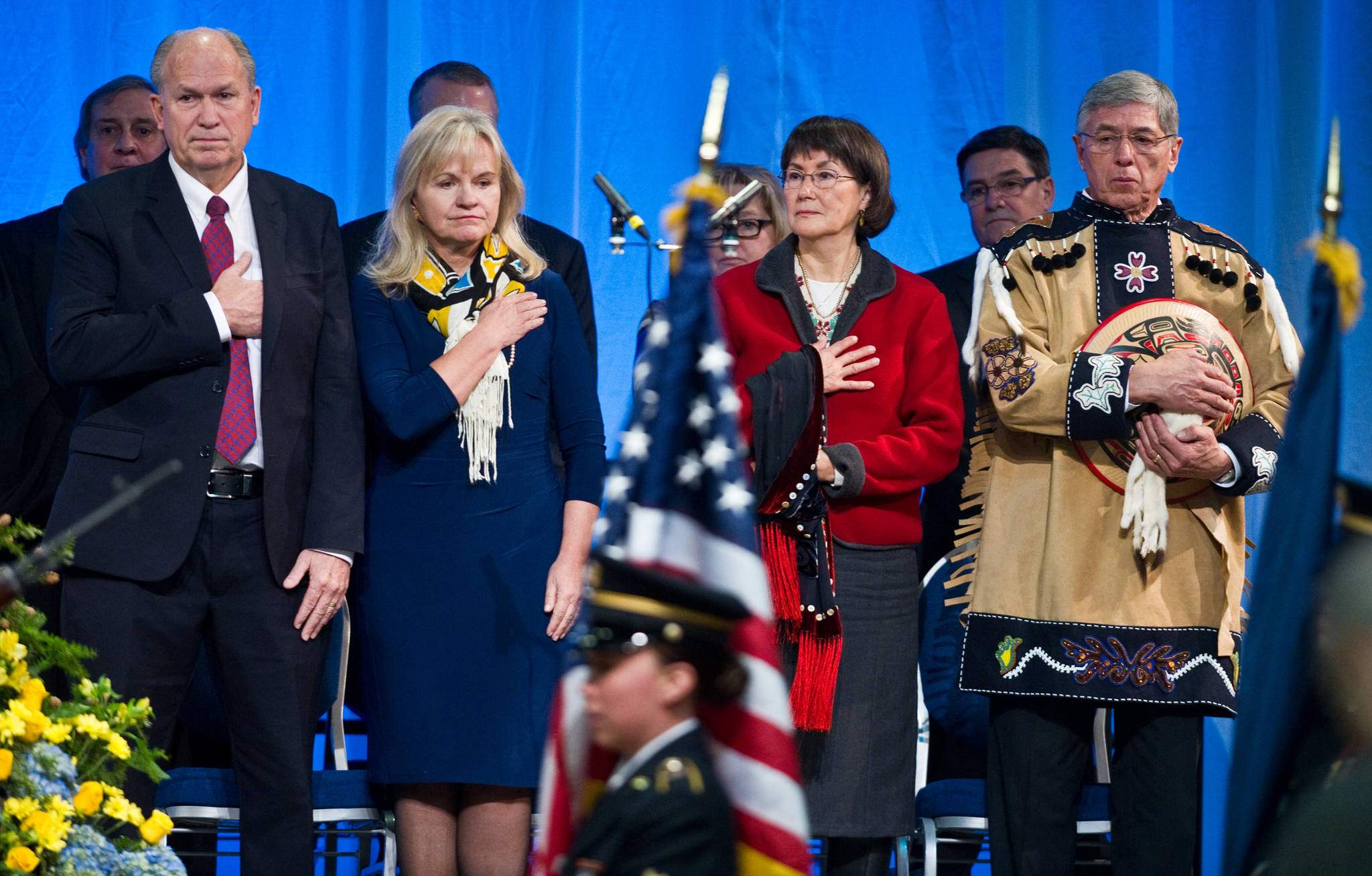 Gov. Bill Walker, left, his wife, Donna, Toni Mallott and her husband, Lt. Gov. Byron Mallott watch a Alaska National Guard honor guard present the colors during the inauguration ceremony at Centennial Hall on Monday.