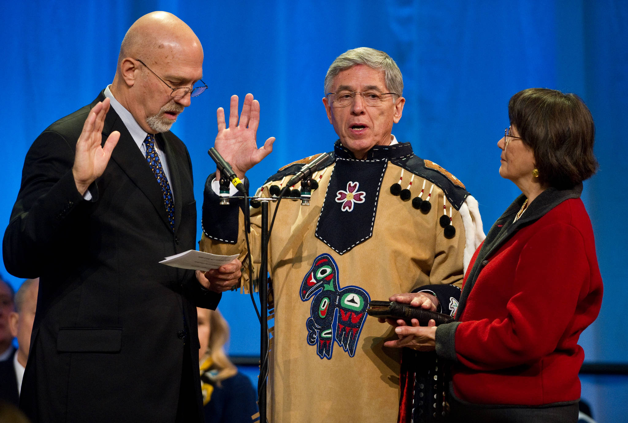 Retired Alaska Supreme Court Justice Walter Carpeneti, left, swears Lt. Gov. Byron Mallott into office as Toni Mallott holds a bible during the inaugural cermony at Centennial Hall on Monday.