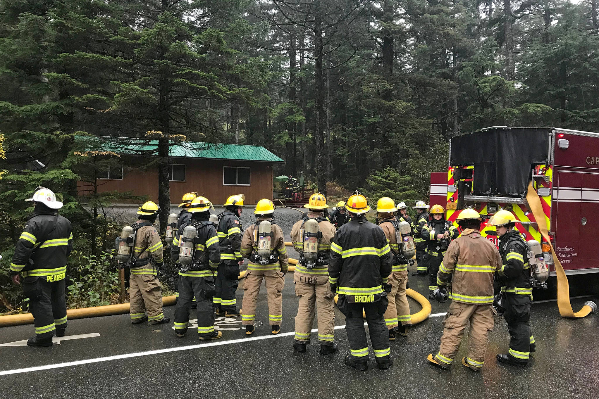 Capital City Fire/Rescue firefighters respond to a house fire on Douglas Highway on Tuesday, Oct. 16, 2018. The owners were not home at the time, and were unharmed, but two dogs died in the blaze. (Alex McCarthy | Juneau Empire)