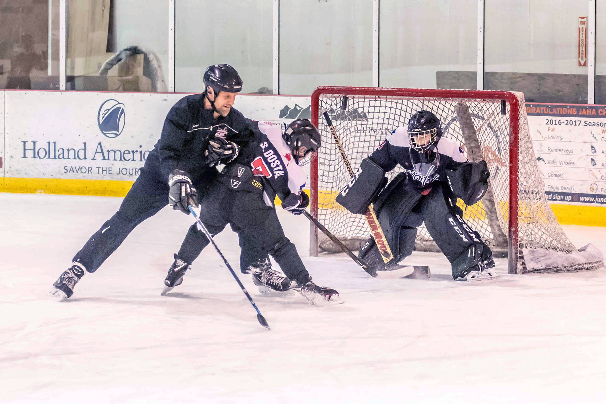 Juneau Capitals 12U AA assistant coach Mike Bovitz provides defensive pressure to player Stein Dostal during a drill. (Courtesy Photo | Steve Quinn)