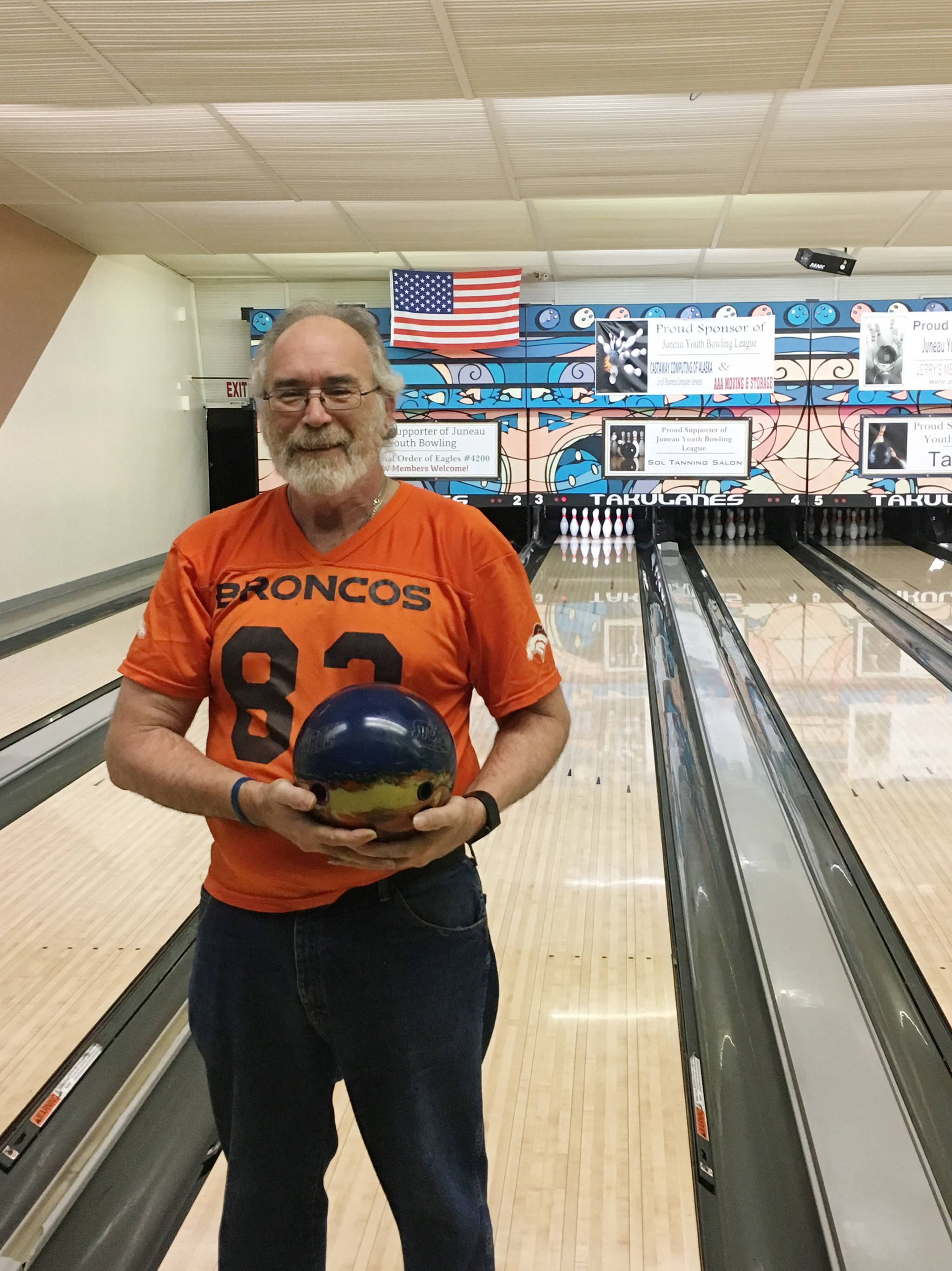Keith Brundige, 59, poses with his lucky ball after bowling a perfect game of 300 on Sunday at Taku Lanes. (Courtesy Photo | Tim Powers)