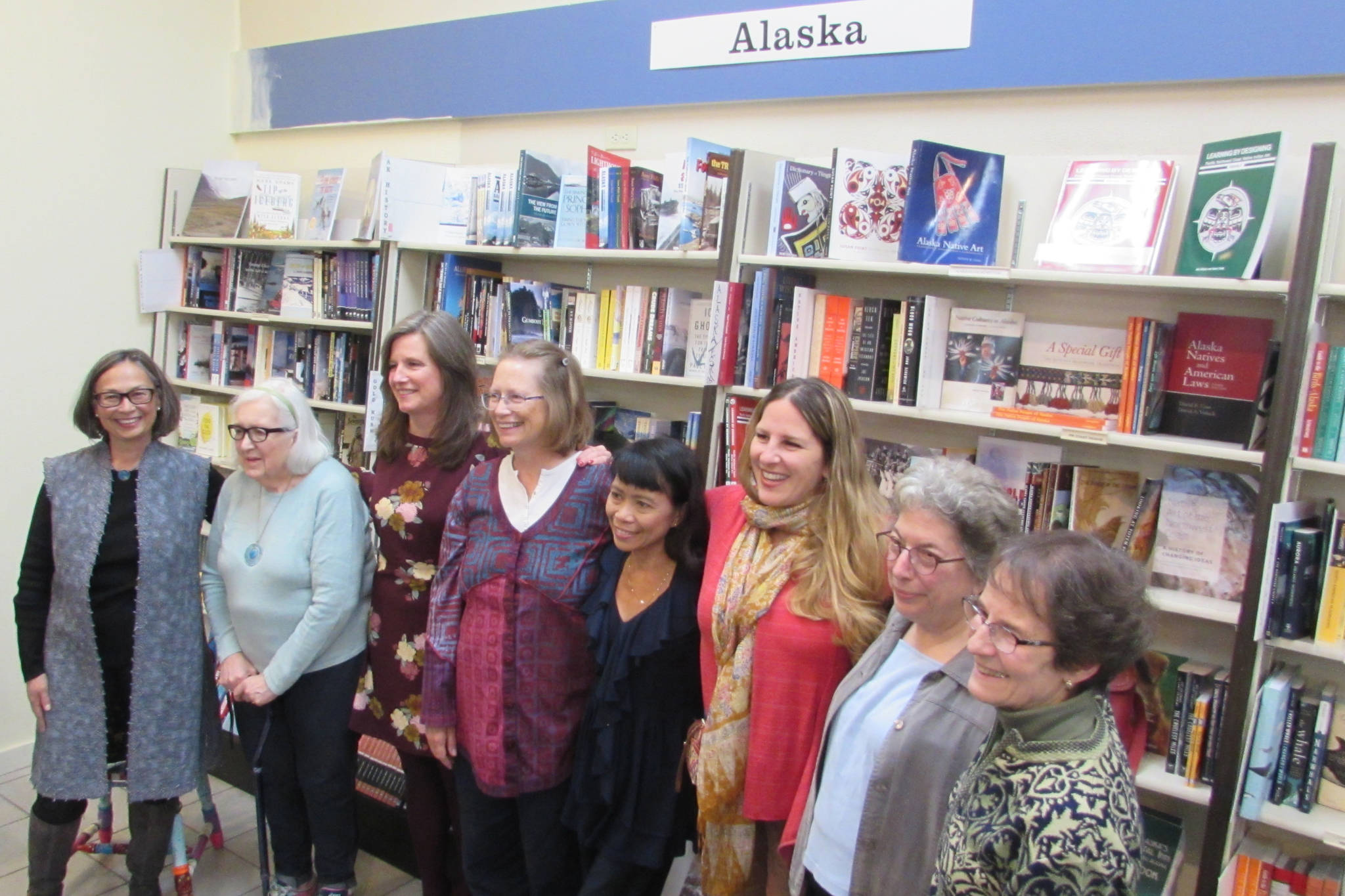 Alaska Women Speak President Carmen Davis stands with writers Mary Lou Spartz, Katie Bausler, Kate Boesser, Miriam Wagoner, Amy Pinney, Margo Waring and Dianne DeSloover at a poetry and prose reading at Hearthside Books in Nugget Mall. (Ben Hohenstatt | Capital City Weekly)