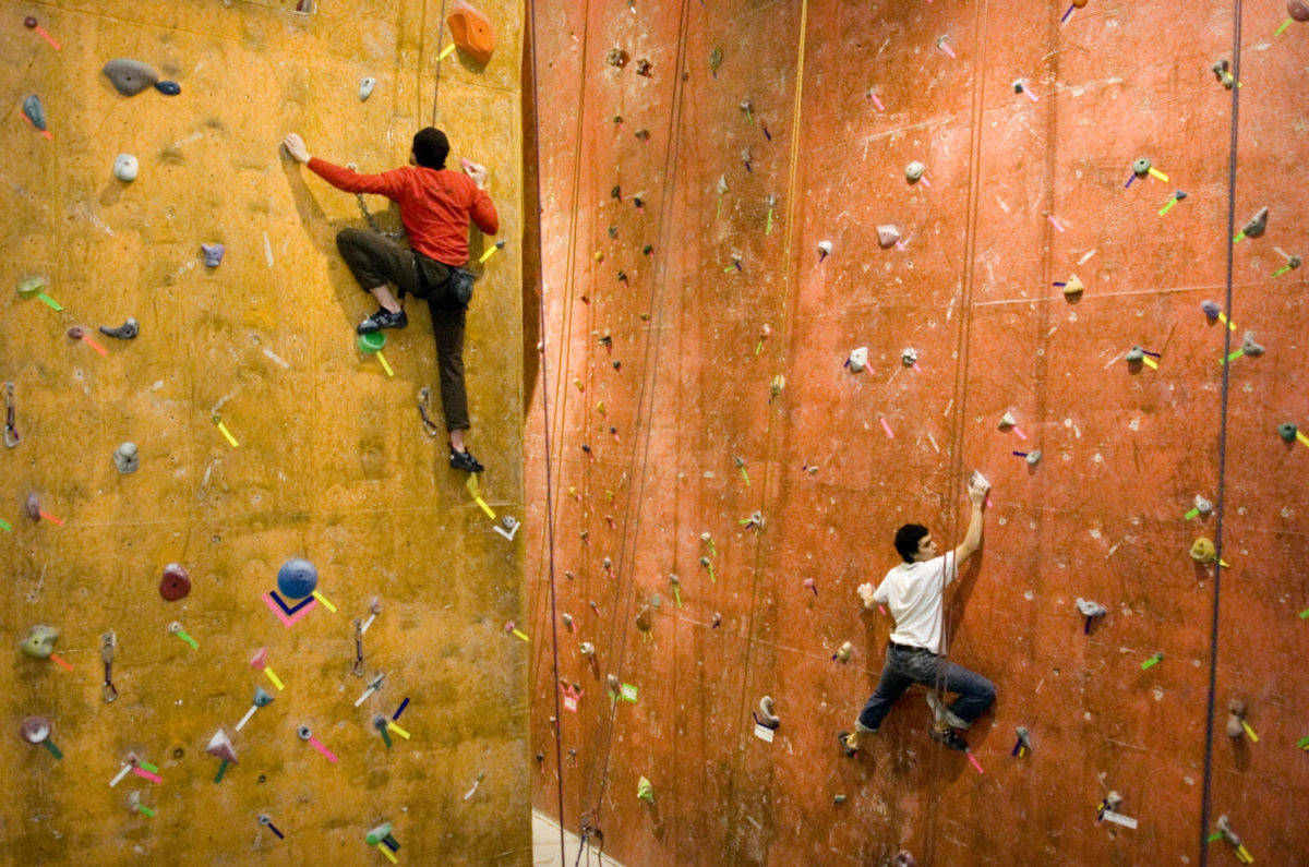 In this 2008 file photo, Nathan Gaudreault, left, and Tyler Gress work their way up The Rock Dump’s climbing walls. (Michael Penn | Juneau Empire)