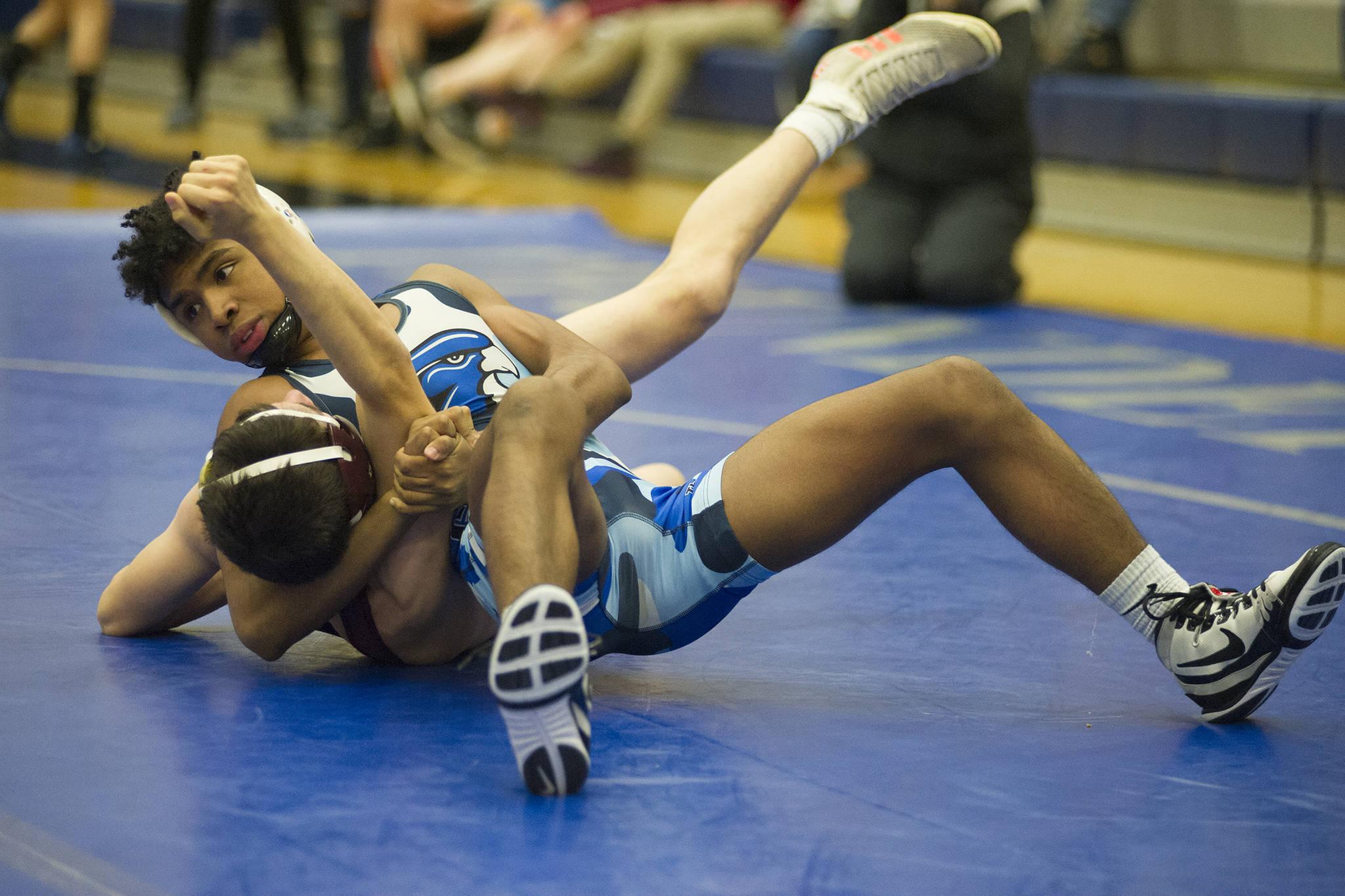 Juneau-Douglas junior Jahrease Mays looks over at the official as he pins Ketchikan’s Patrick Rauwolf in the 125-pound bracket final of the Brandon Pilot Invitational on Saturday at Thunder Mountain High School. Mays won by pin at 1:10. (Nolin Ainsworth | Juneau Empire)